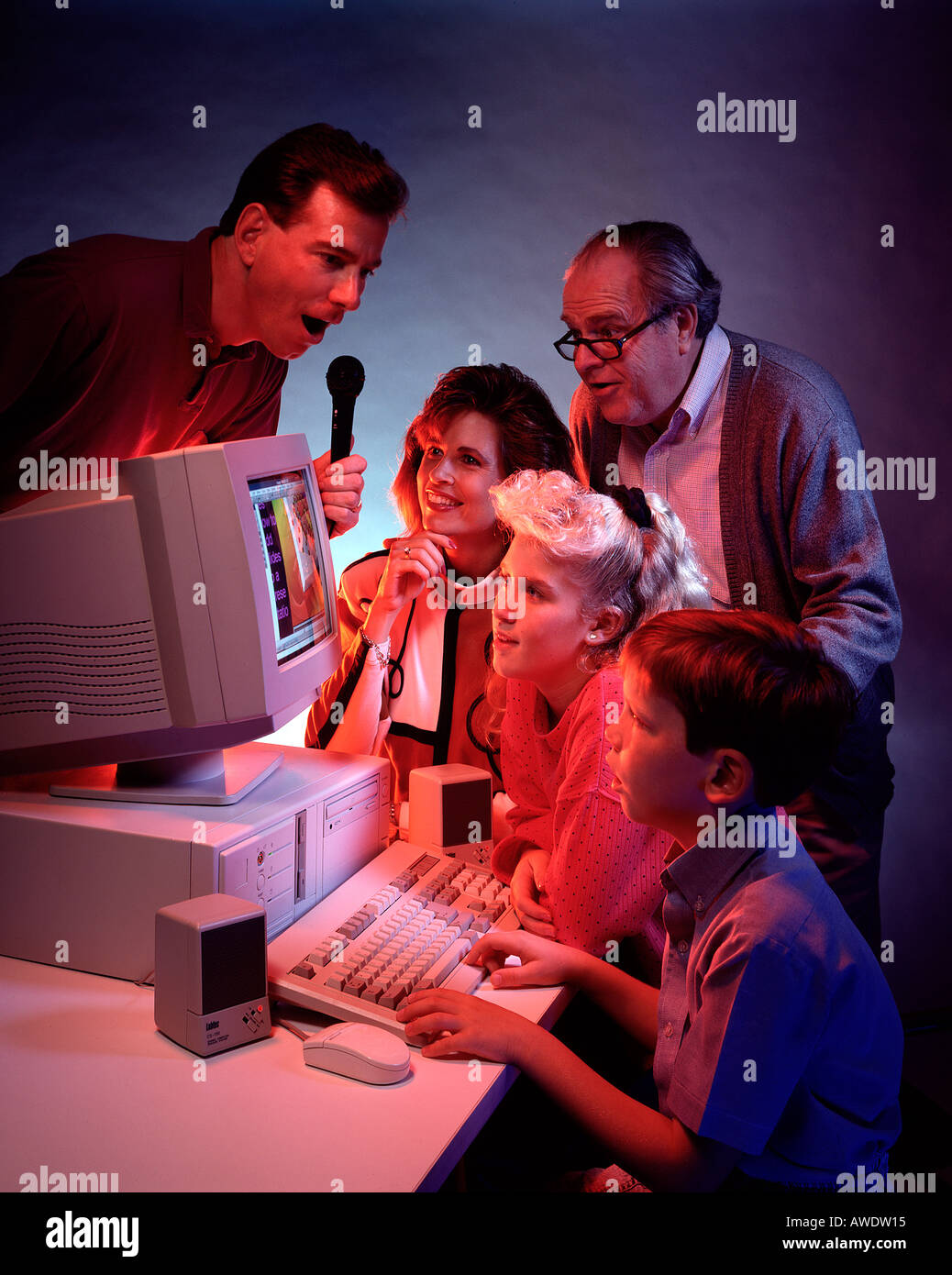 multi generation family gather round computer Stock Photo - Alamy