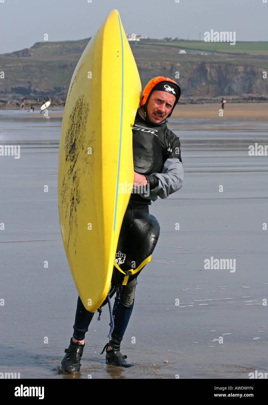 man holding a yellow kayak on the beach Stock Photo - Alamy