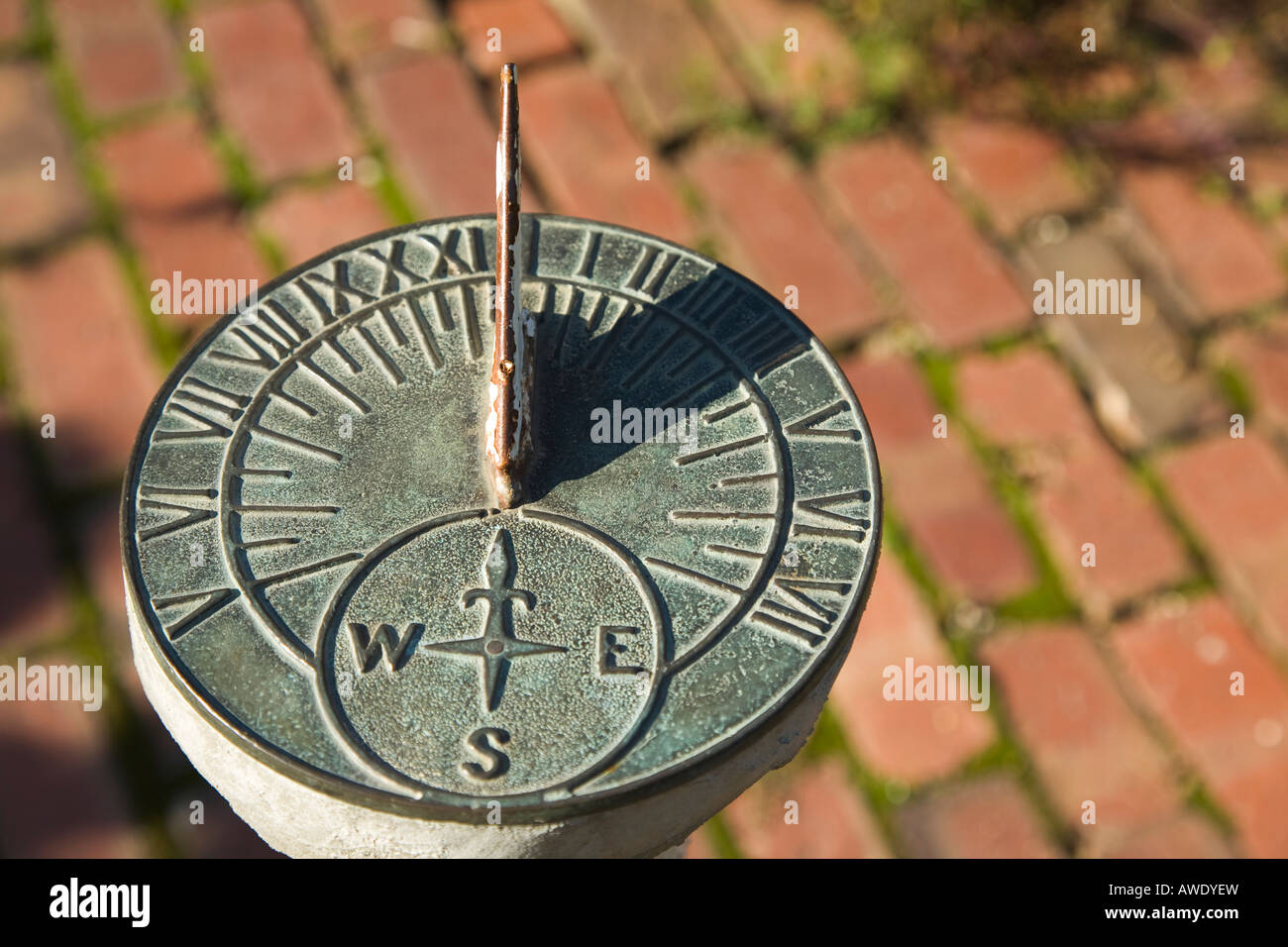 ILLINOIS Rockford Shadow on sun dial brick sidewalk in garden historic Midway Village Stock Photo