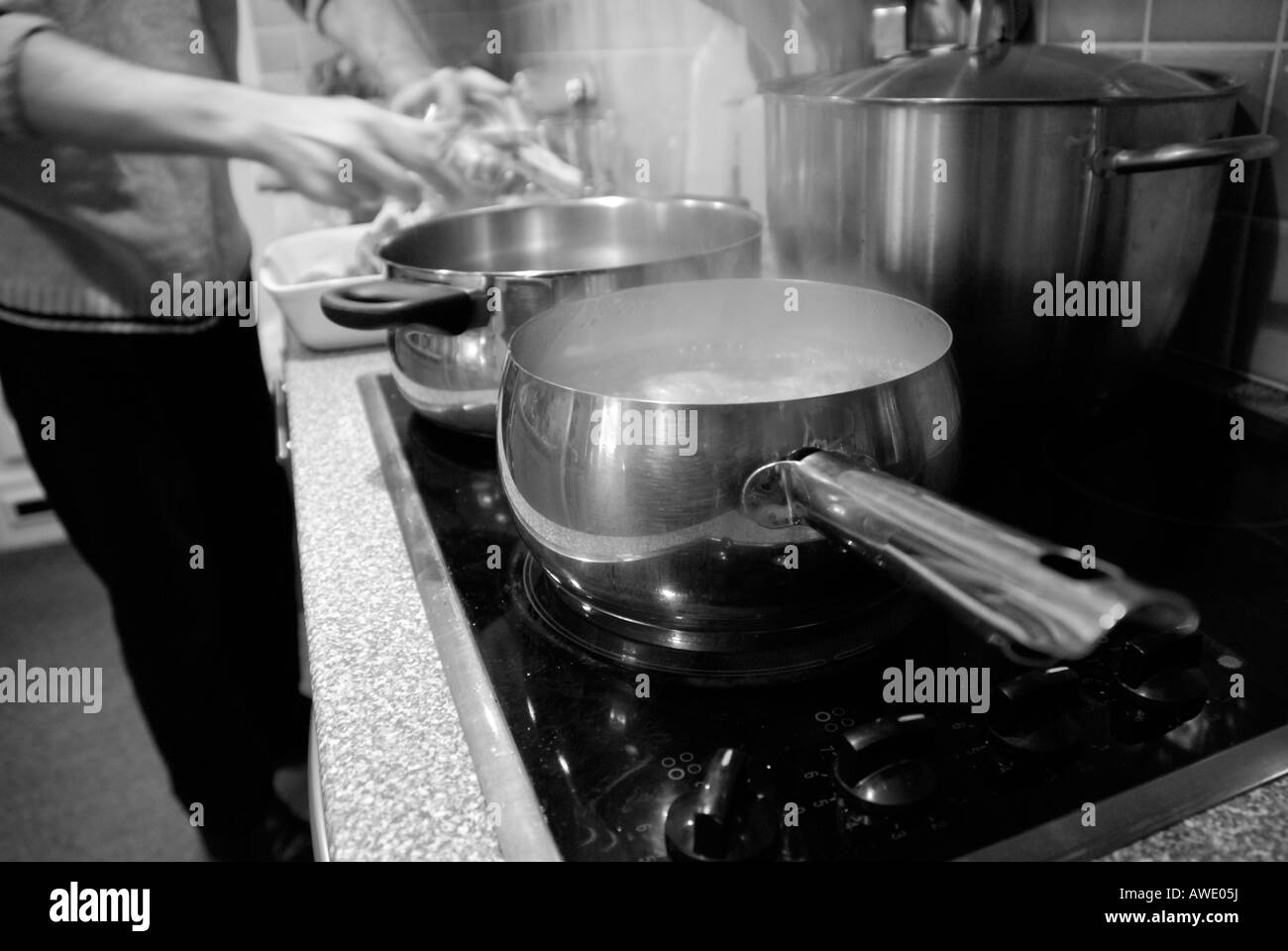 Man Preparing Food Close Up Of Pots And Pans On Electric Stove