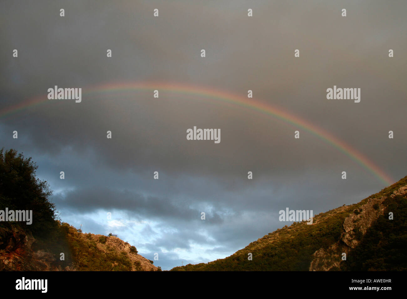 Rainbow between dark clouds hi-res stock photography and images - Alamy