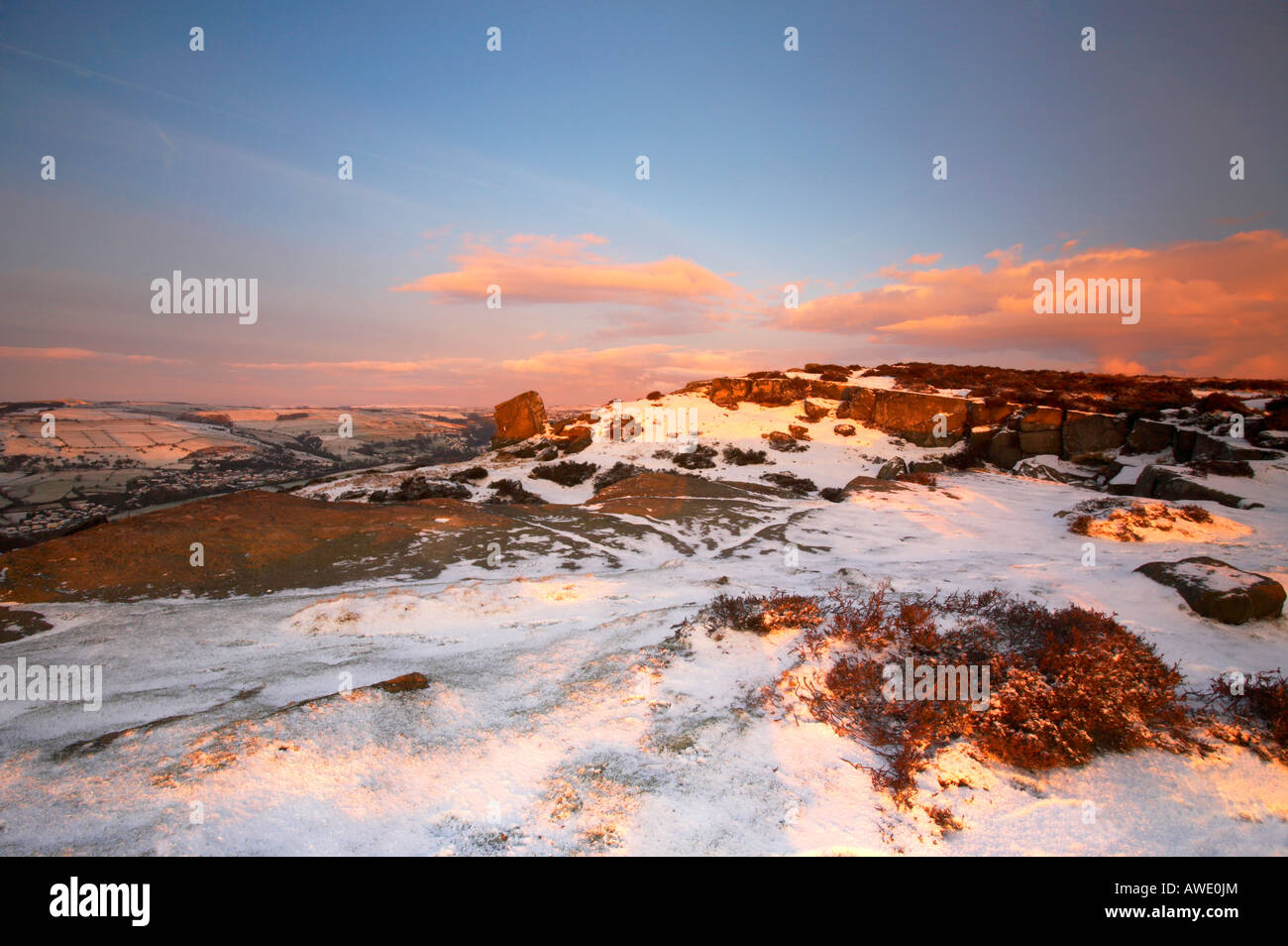 Winter scene at sunrise on a snow covered Curbar edge in Derbyshire Peak District Stock Photo