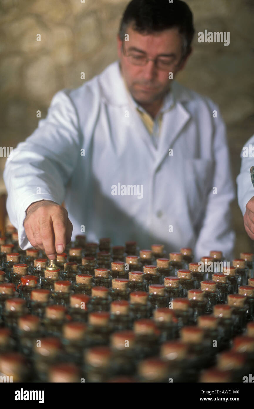 Wax sealing olive oil bottles at the Nunez de Prado olive oil factory