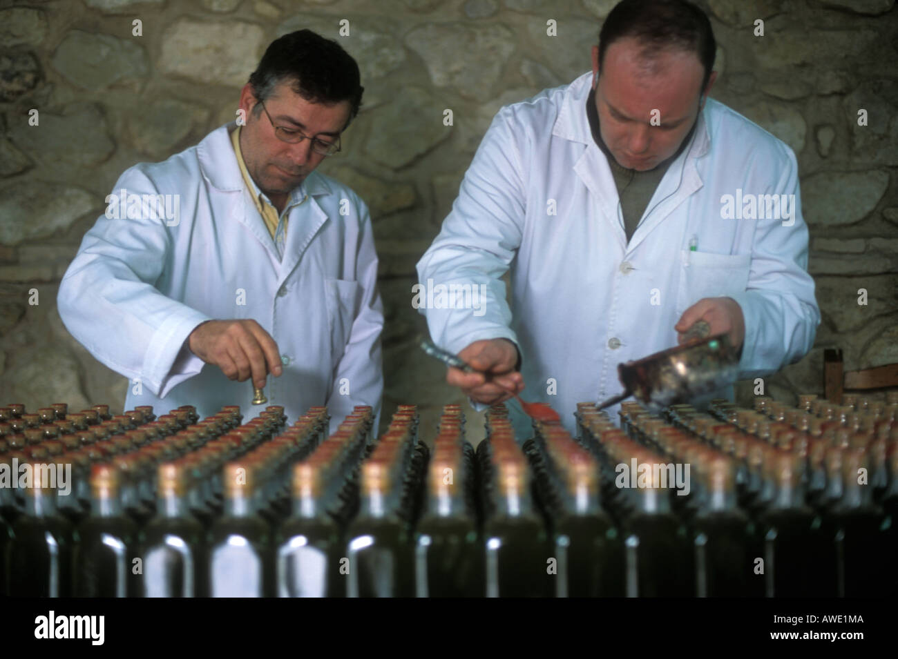 Wax sealing olive oil bottles at the Nunez de Prado olive oil factory