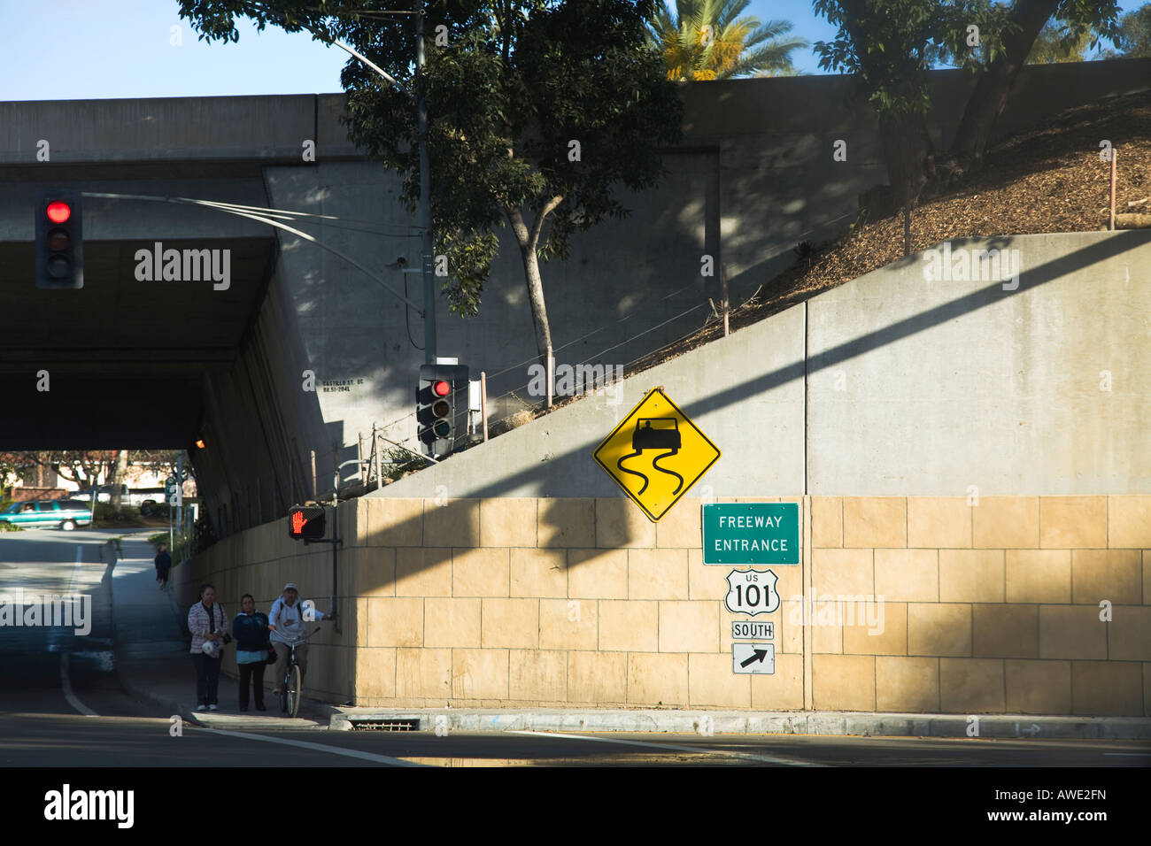 CALIFORNIA Santa Barbara Freeway entrance sign to highway man on bicycle pushing walk signal traffic lights Stock Photo