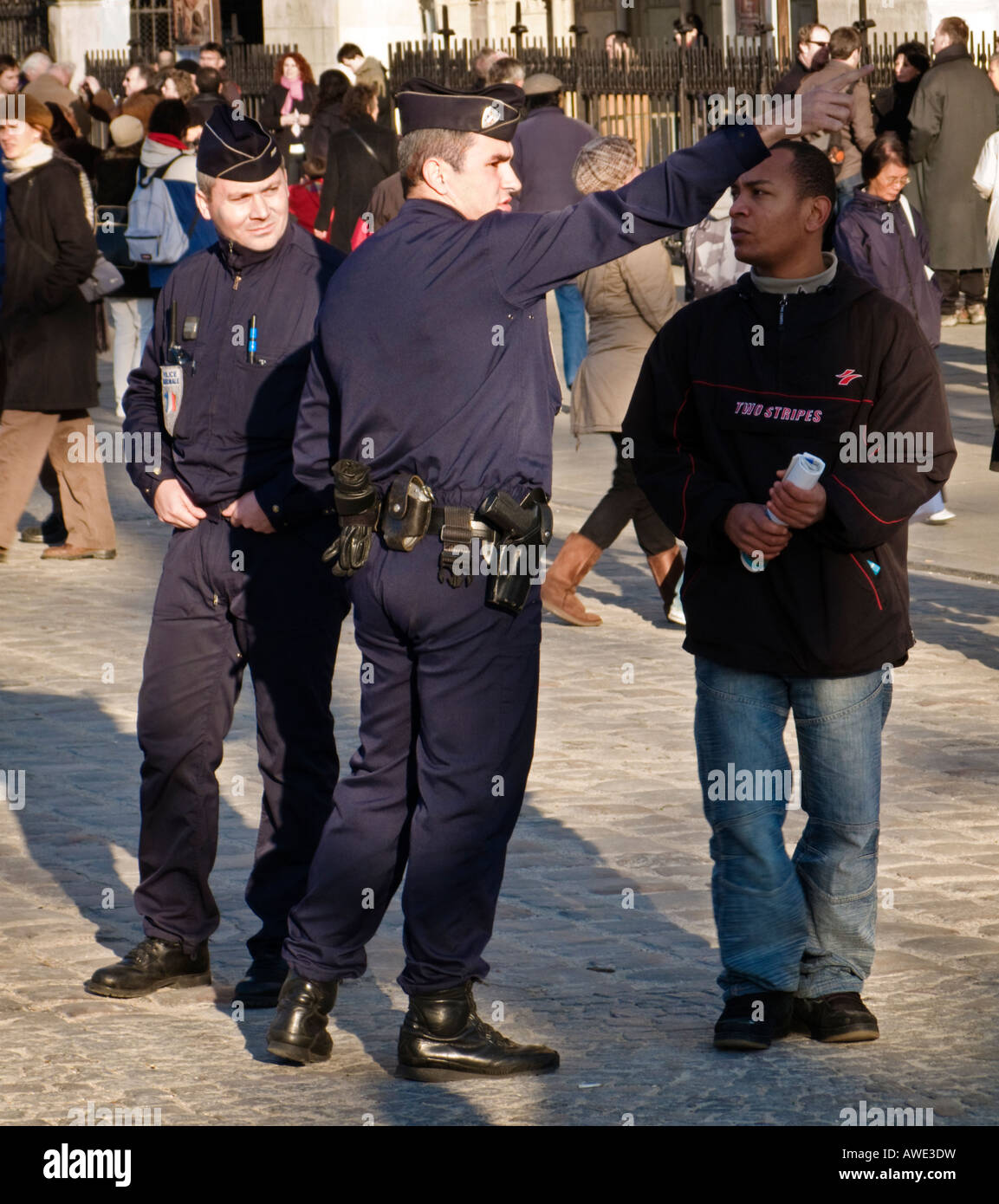 French National Policeman gives directions to a tourist outside Notre Dame Paris France Europe Stock Photo