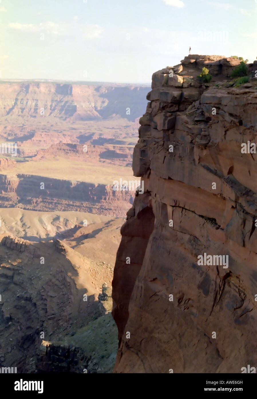 A distant view of one of the cliffs in Dead Horse National Park in S. Utah, USA. Look closely. You can see a tiny person on top. Stock Photo