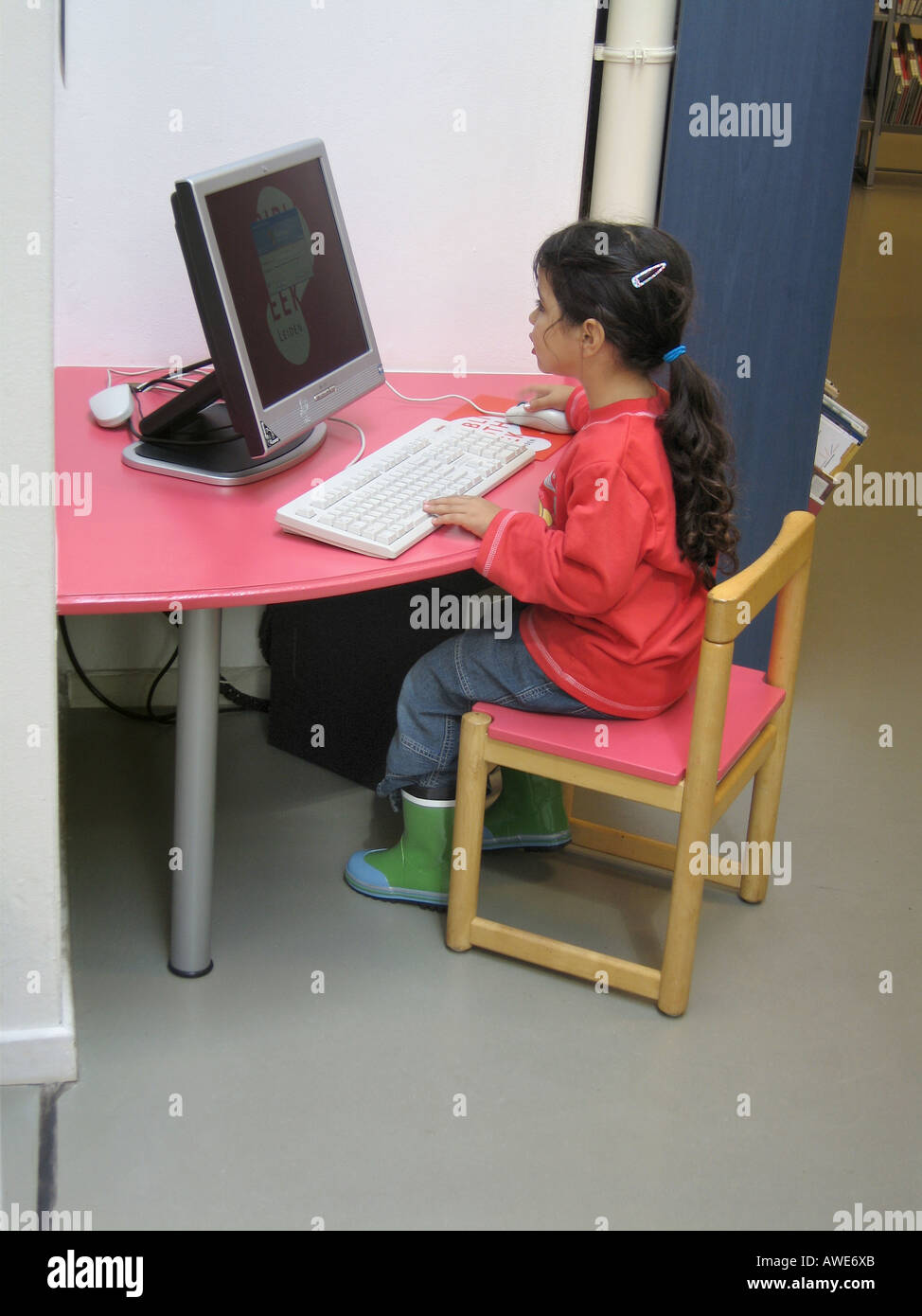 Little girl behind a computer Stock Photo - Alamy