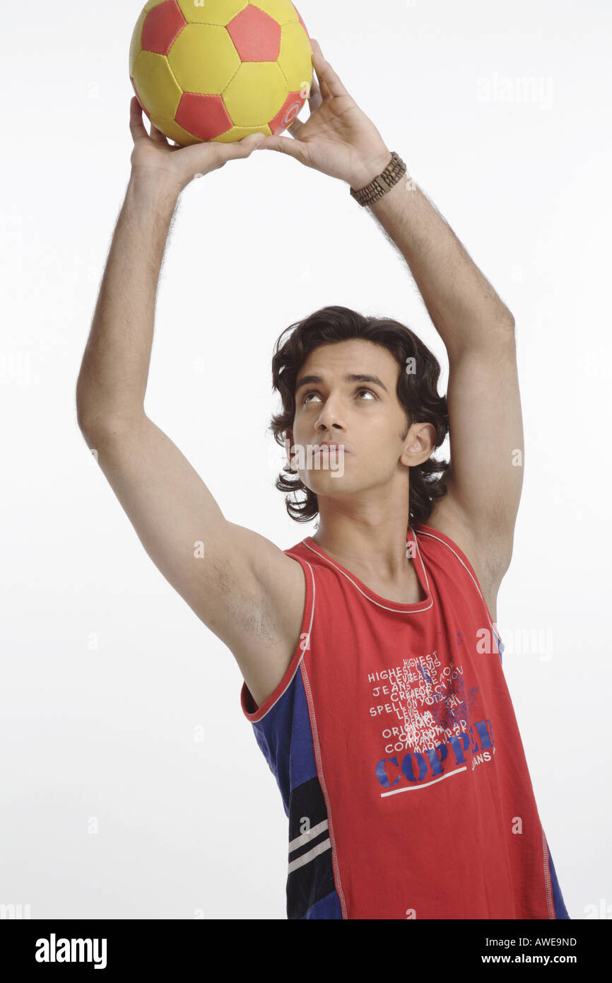 ANG200564 Teenage boy holding football with both hands and trying to throw MR 687T Stock Photo