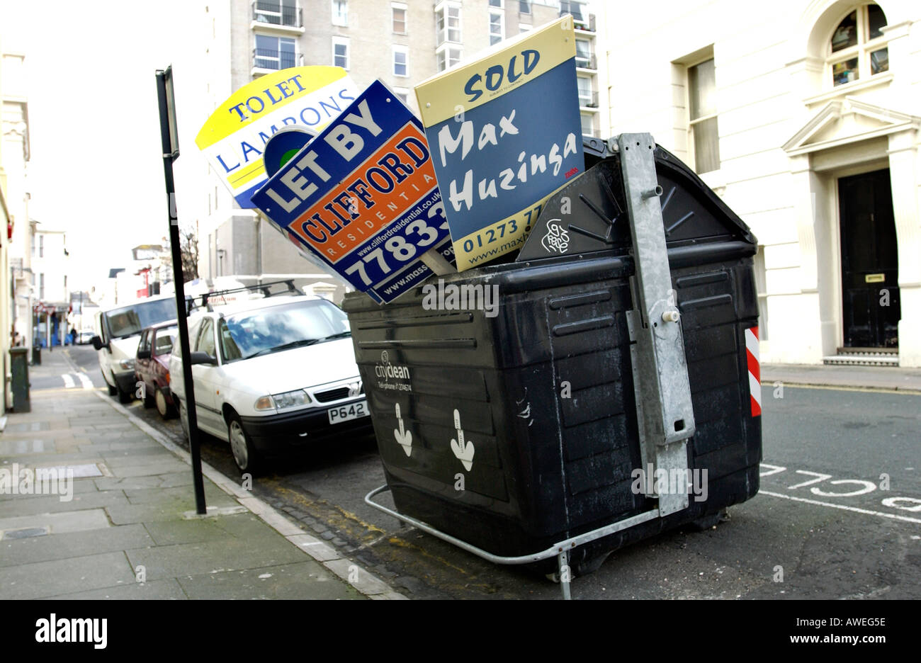 Discarded House Sold and To Let signs are crammed into a Brighton And Hove City Council Waste Bin Stock Photo