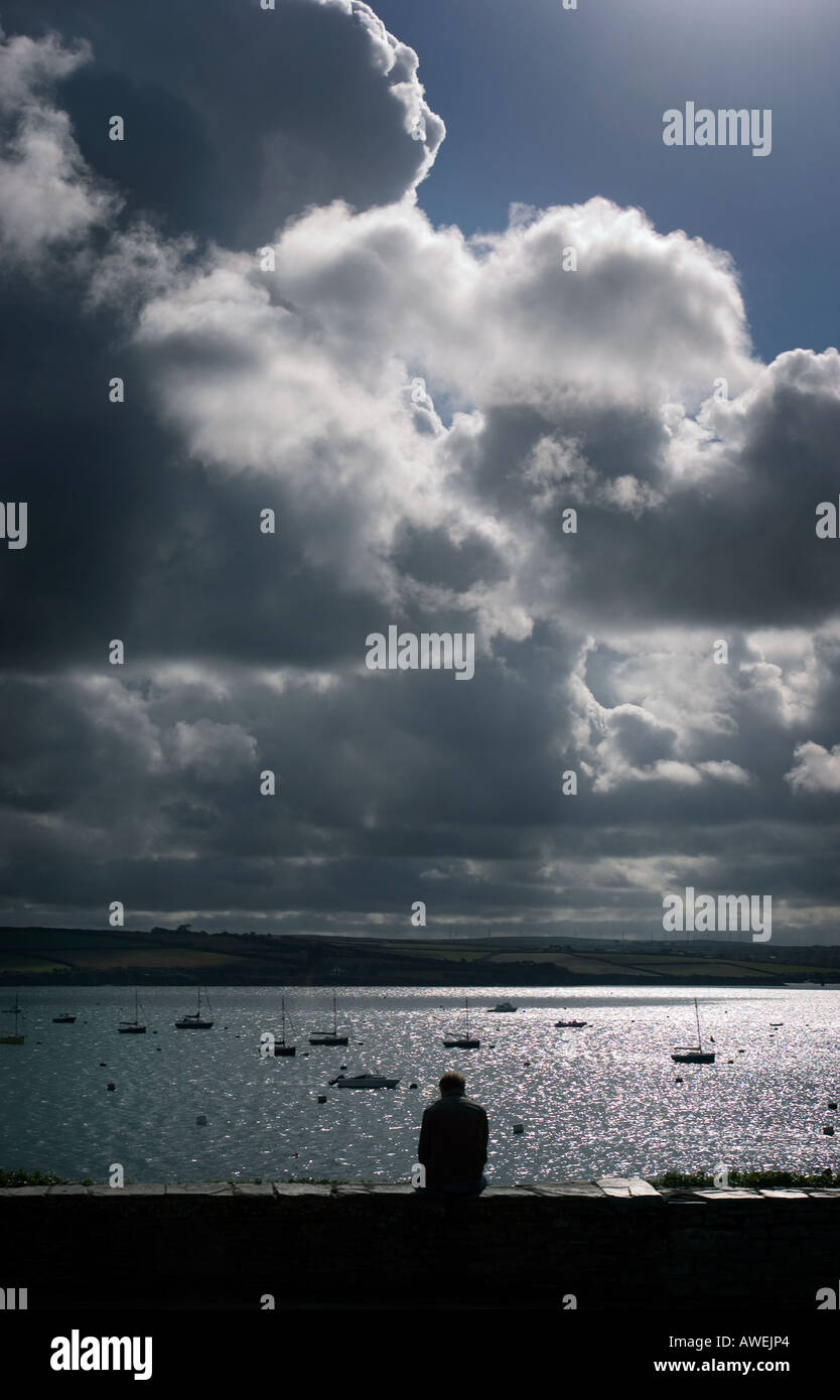 A man overlooks the bay at Padstow Stock Photo