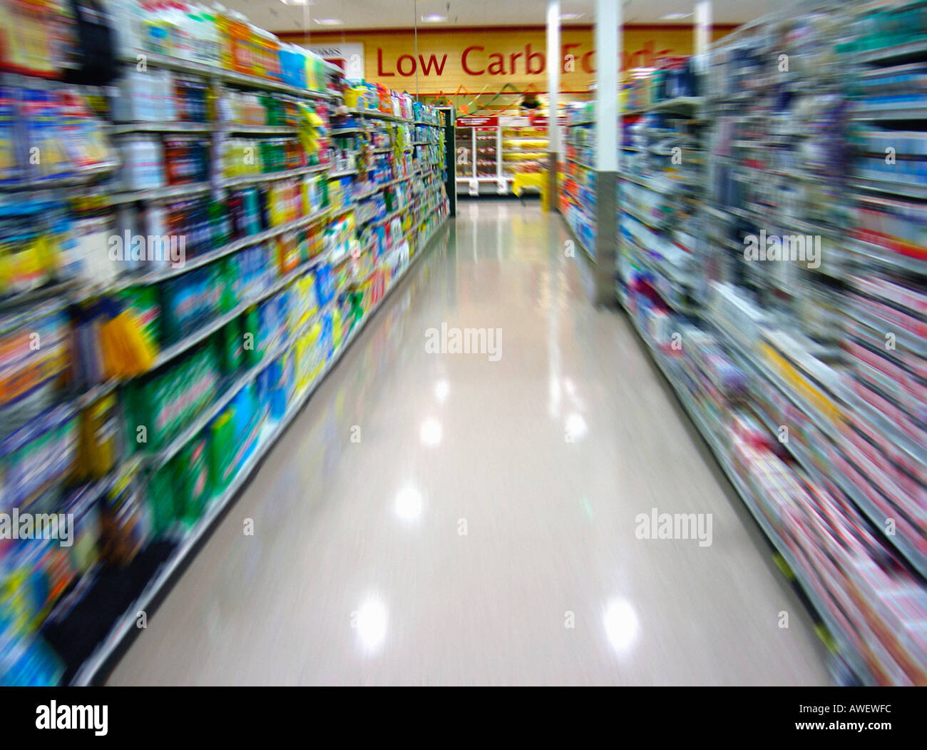 Motion Blurred Image of an Aisle in a Supermarket and Low Carb Sign on Wall No People Copy Space Stock Photo