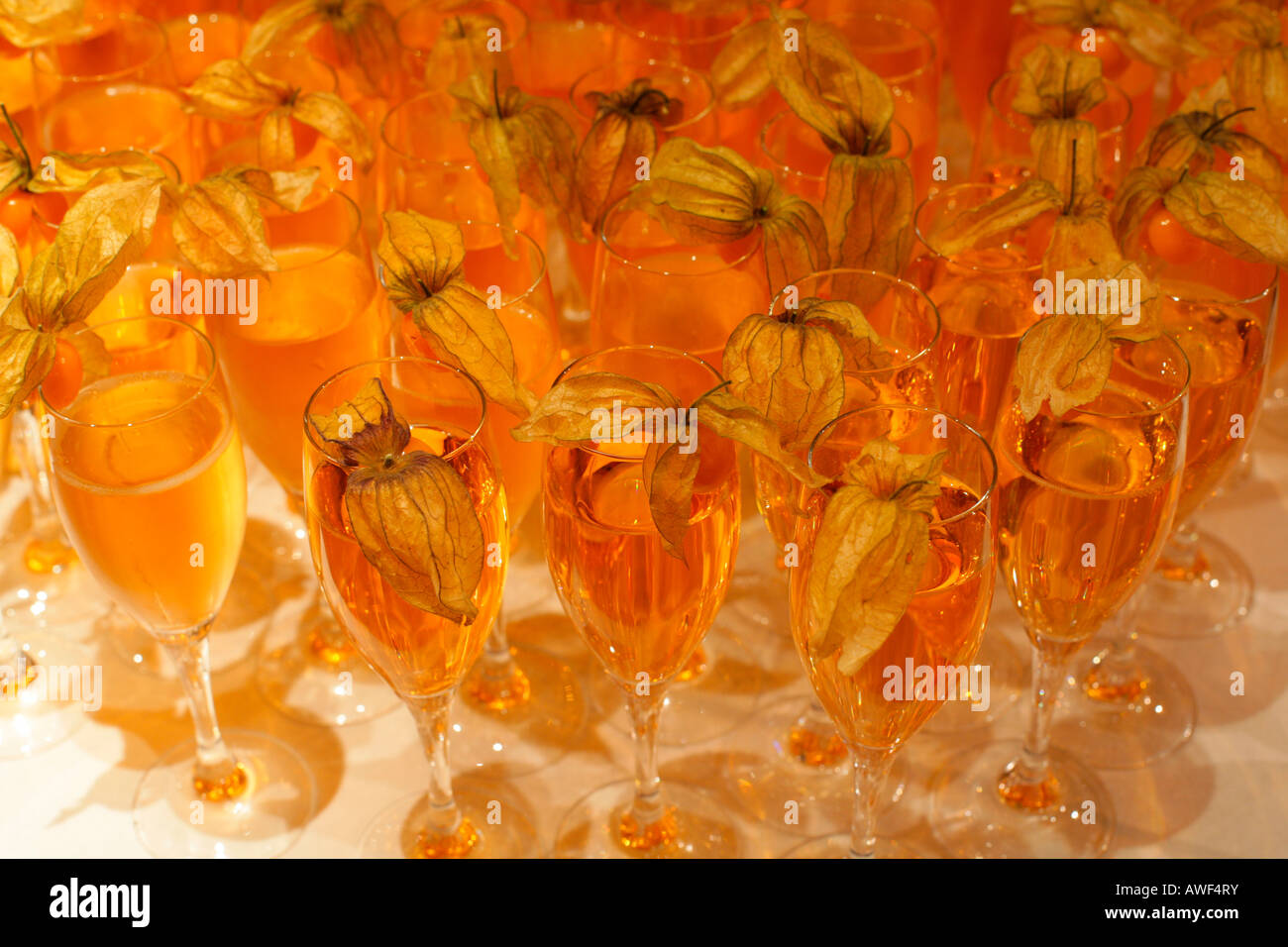 Champagne glasses garnished with Chinese lantern fruit Stock Photo