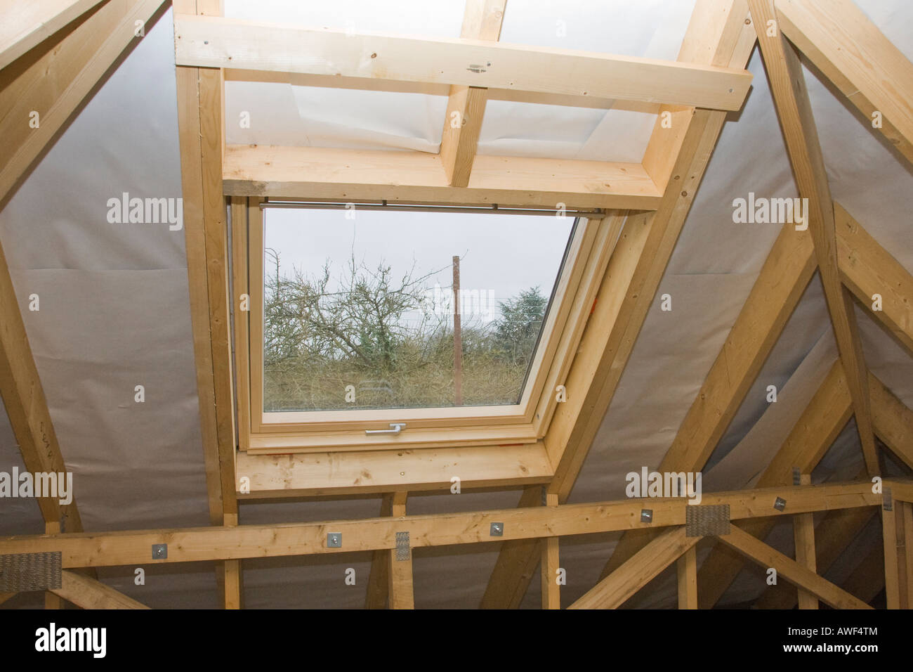 Velux roof window fits in a loft conversion being built Stock Photo