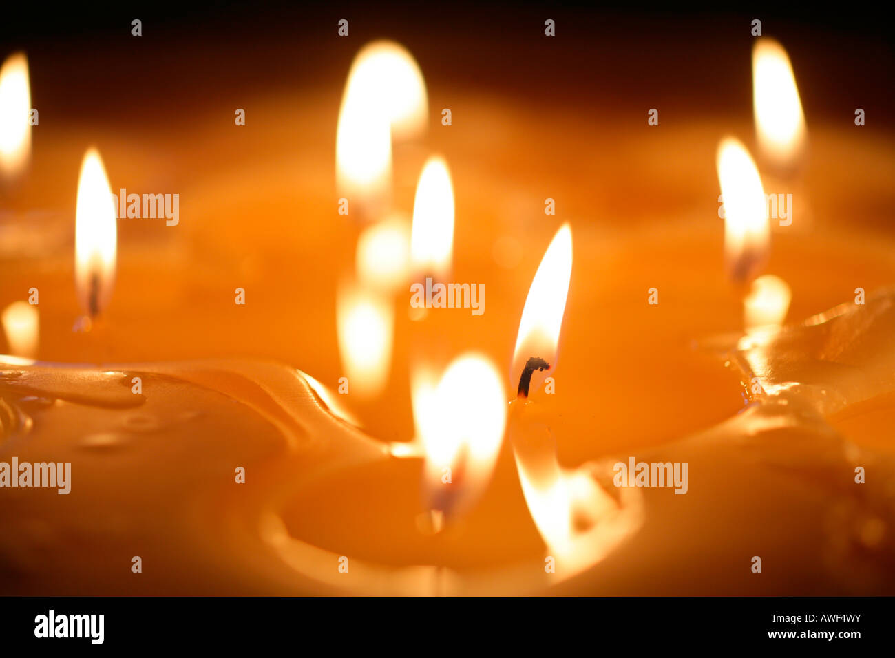 Large candle with multiple burning wicks Stock Photo Alamy