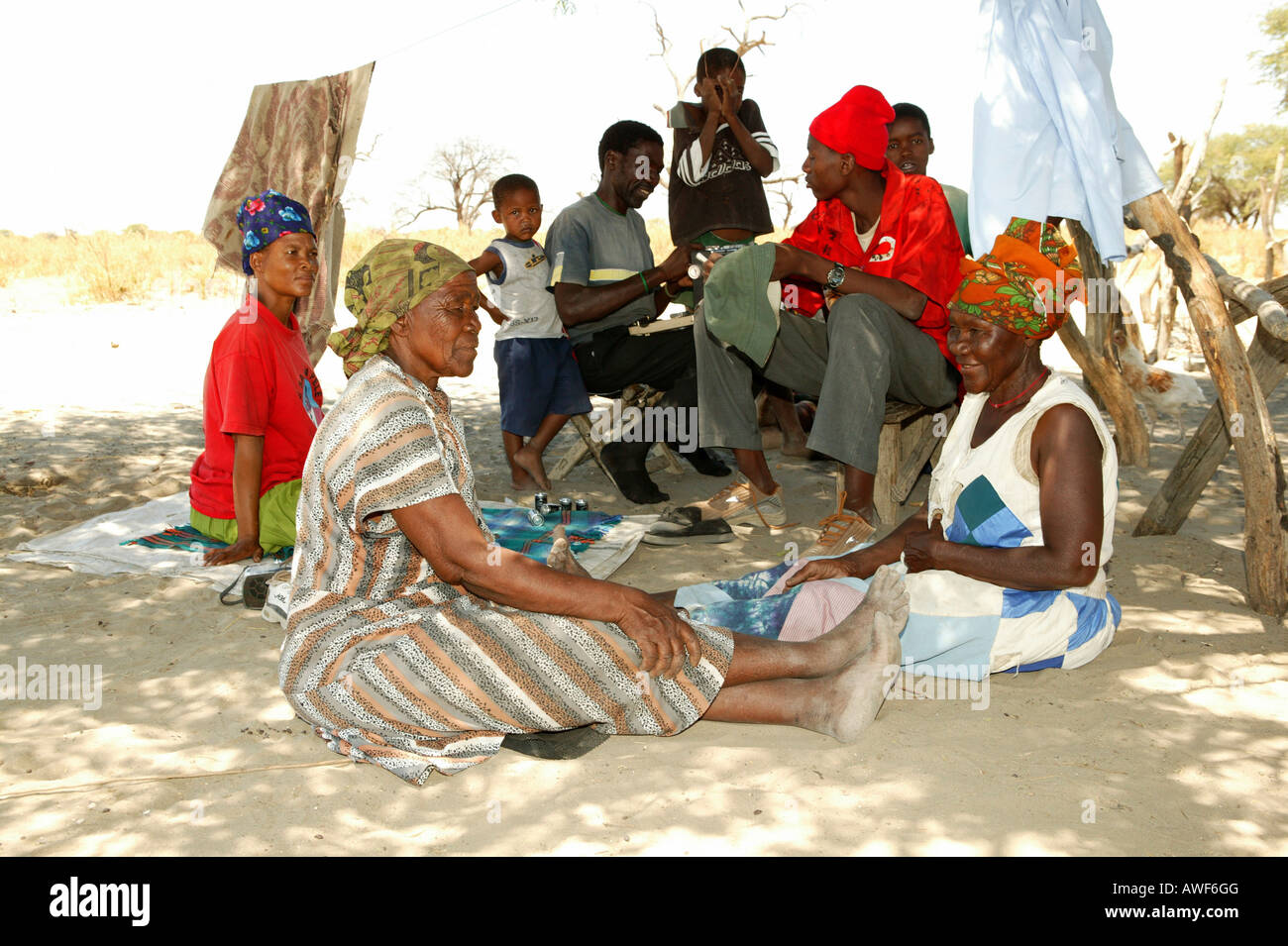 Village life in the shade of a tree, Sehitwa, Botswana, Africa Stock Photo