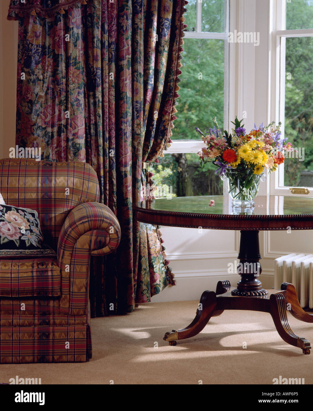 Antique Table In Front Of Large Window With Blue Pink Floral