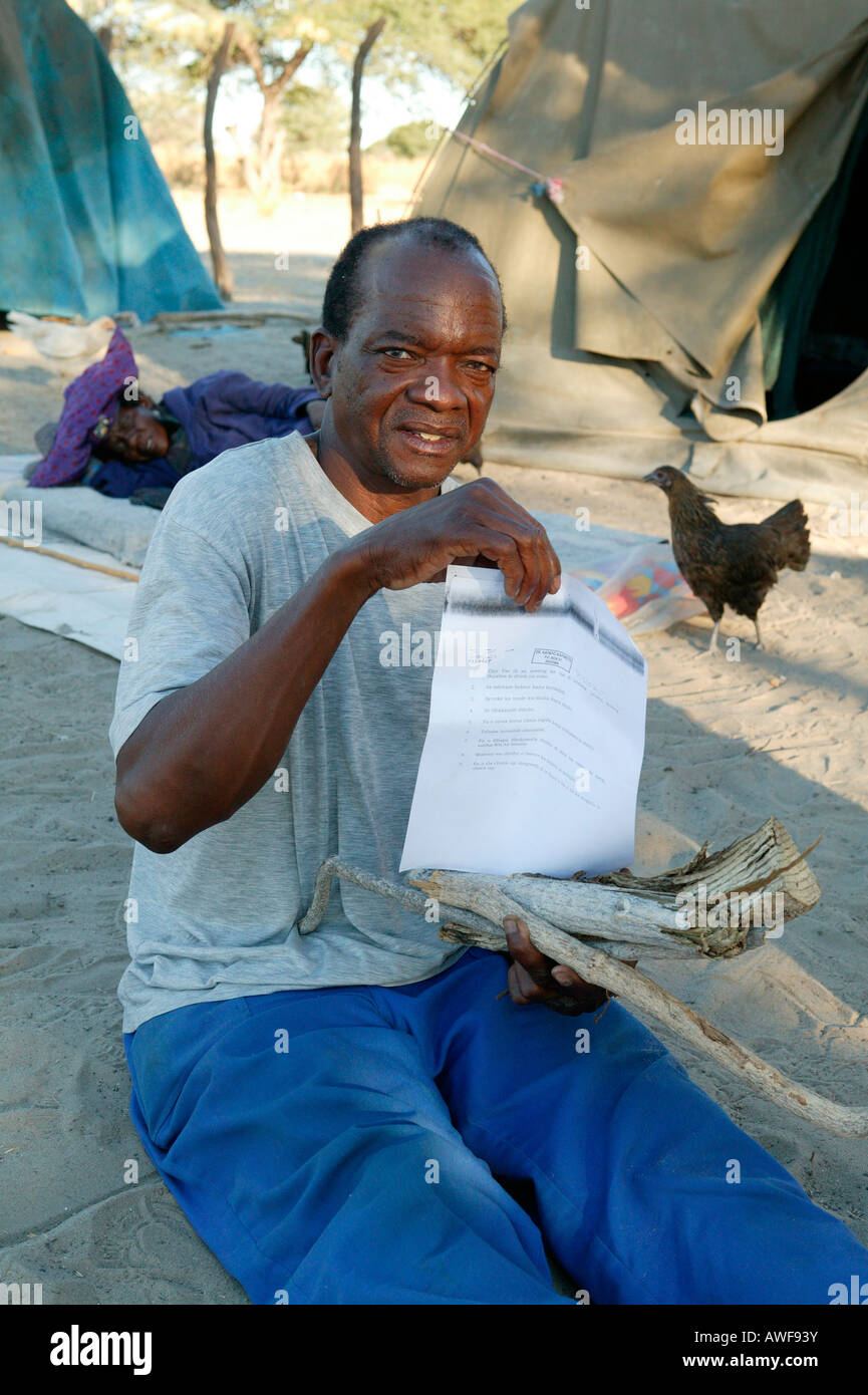 Traditional healer's patient displaying his 'prescription' for medicinal herbs, Sehitwa, Botswana, Africa Stock Photo