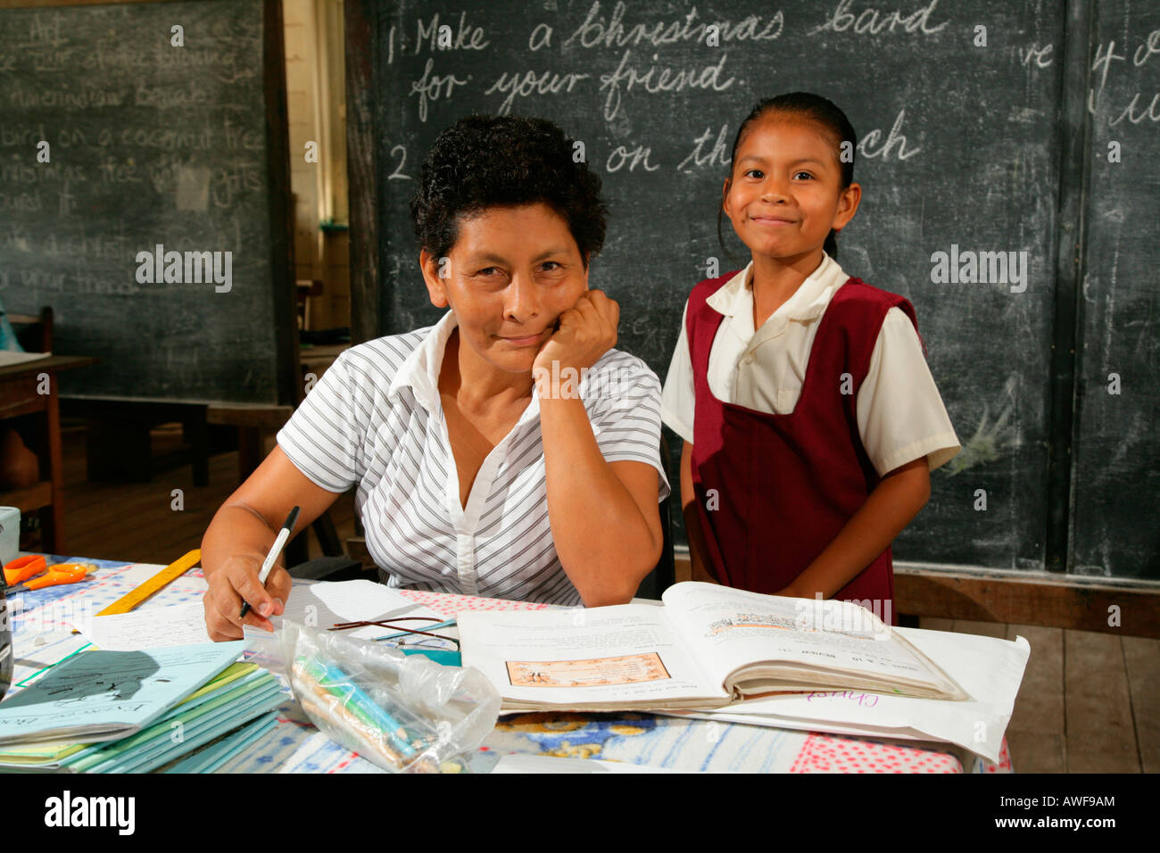 Schoolgirl and her teacher during class, Arawak natives, Santa Mission, Guyana, South America Stock Photo