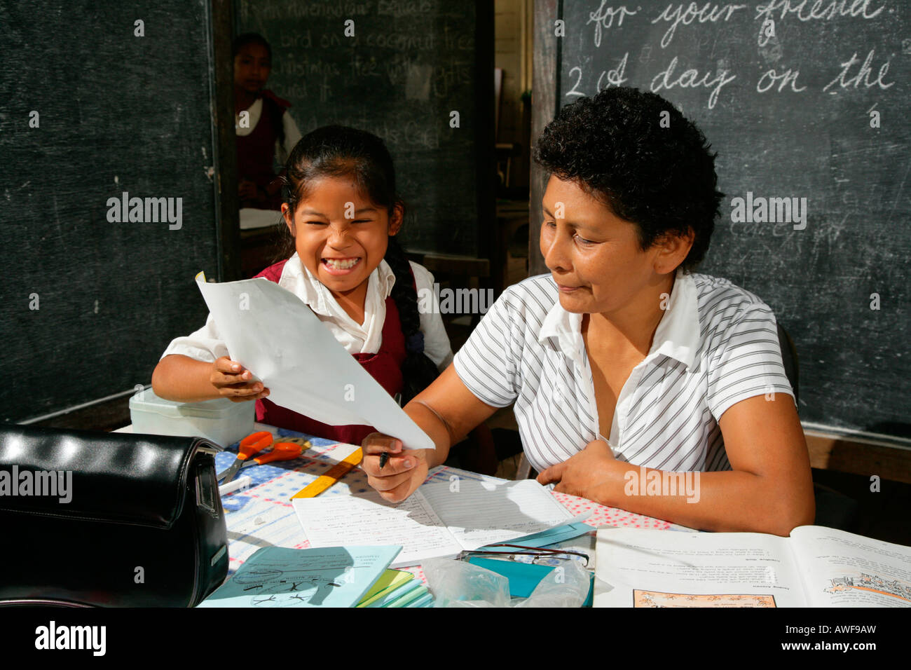 Schoolgirl and her teacher during class, Arawak natives, Santa Mission, Guyana, South America Stock Photo