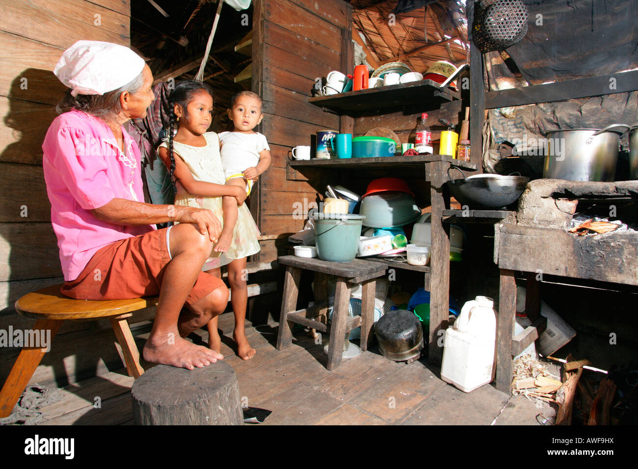 Grandmother with grandchildren in the kitchen, Amerindians of the Arawak tribe, Santa Mission, Guyana, South America Stock Photo