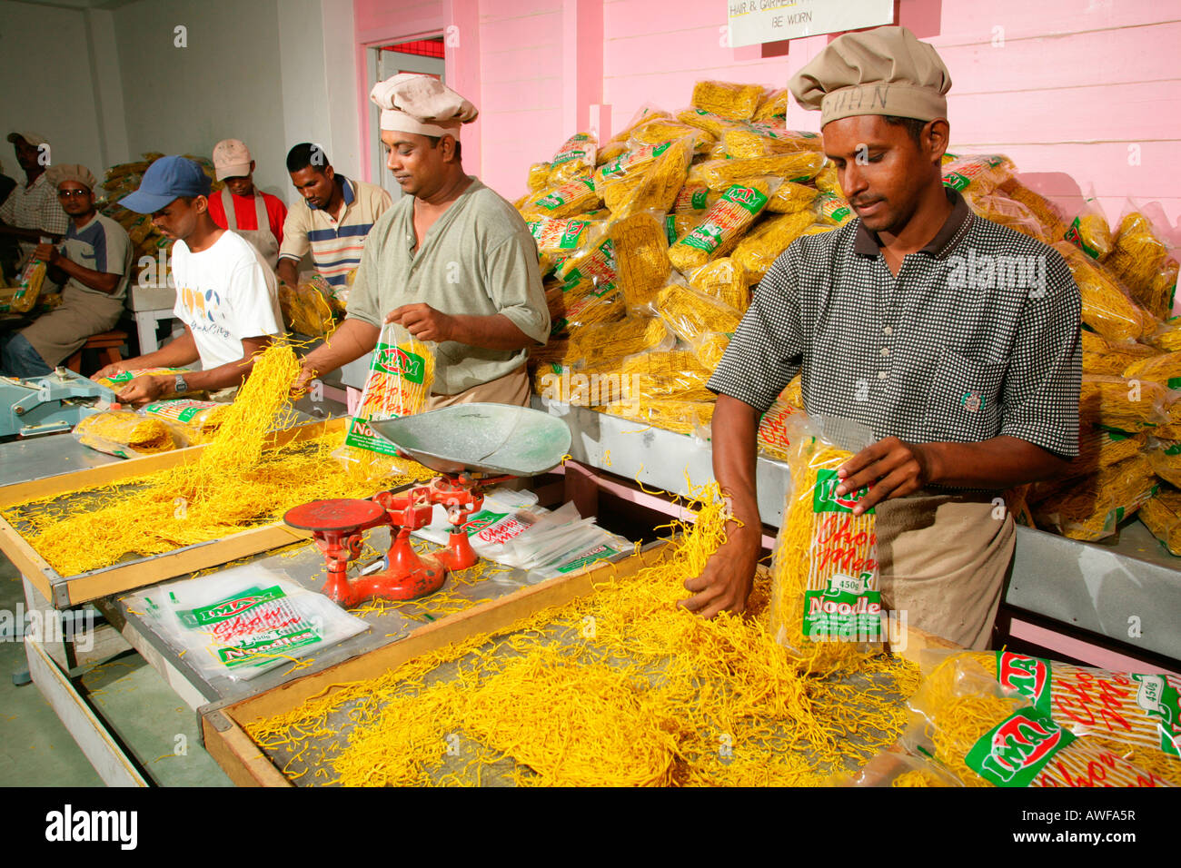 Workers packaging pasta at pasta factory, Demerara Province, Guyana