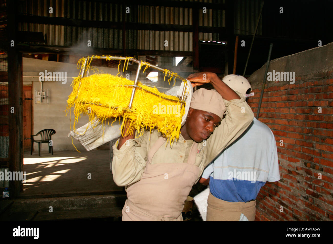 Workers engaged in the production of pasta at pasta factory, Demerara Province, Guyana, South America Stock Photo