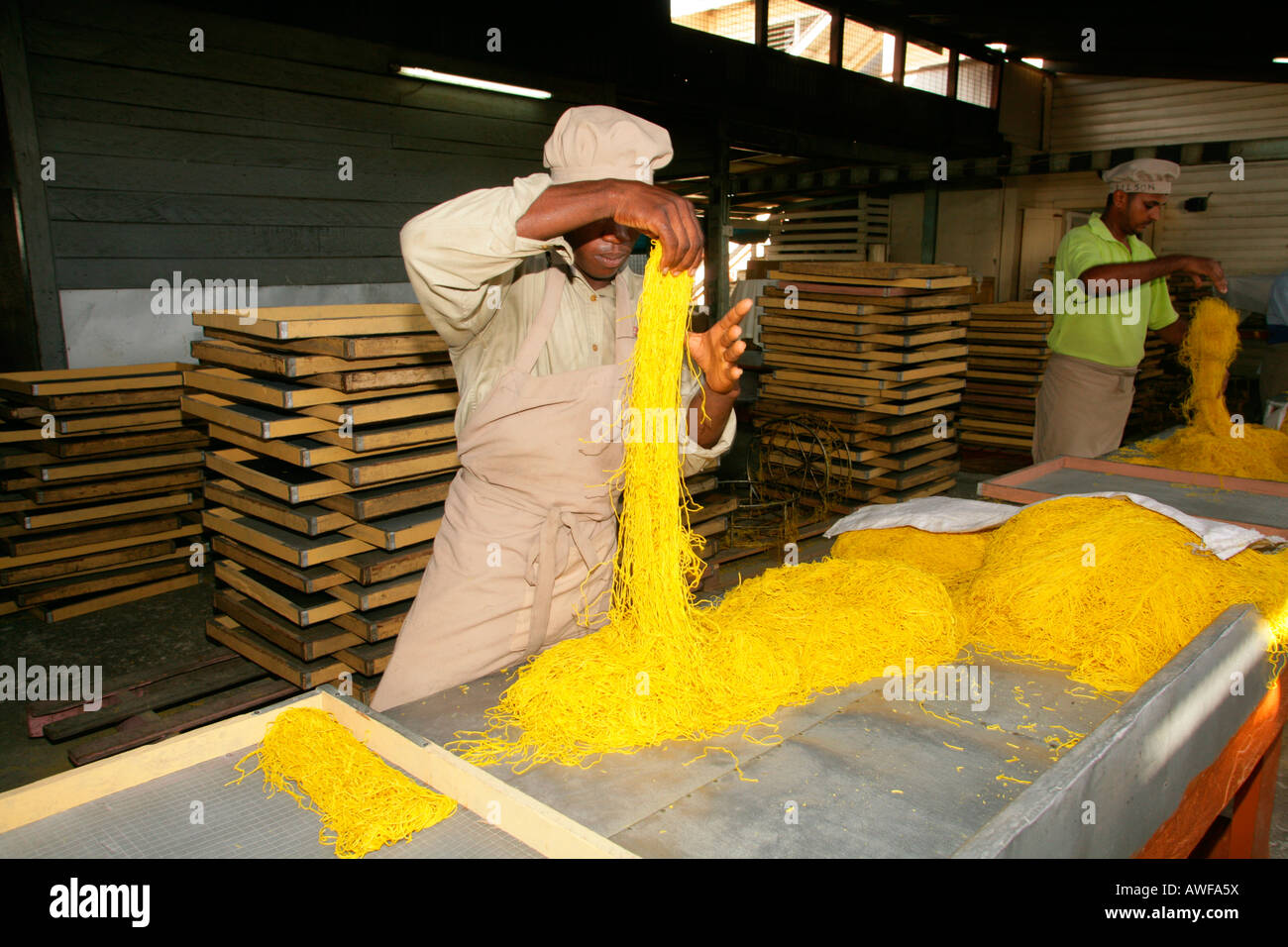 Workers engaged in the production of pasta at pasta factory, Demerara Province, Guyana, South America Stock Photo