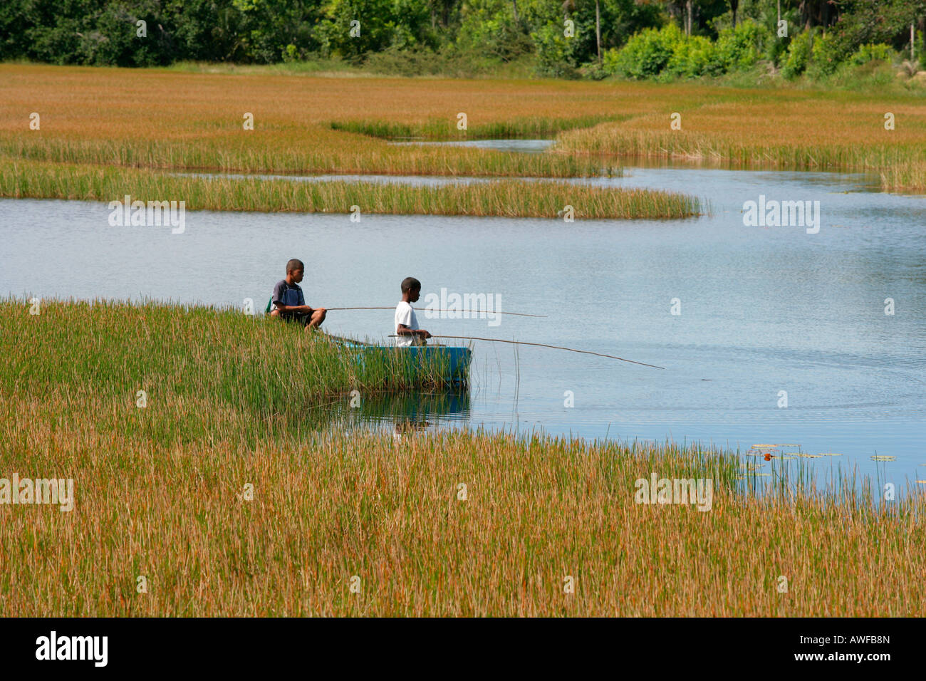 Children fishing in Lake Capoey, Guyana, South America Stock Photo