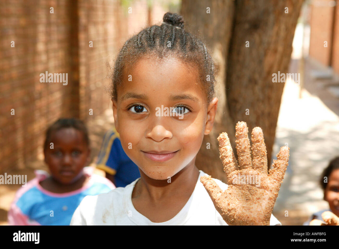 Girl showing her sandy hand at a kindergarten, Gaborone, Botswana, Africa Stock Photo