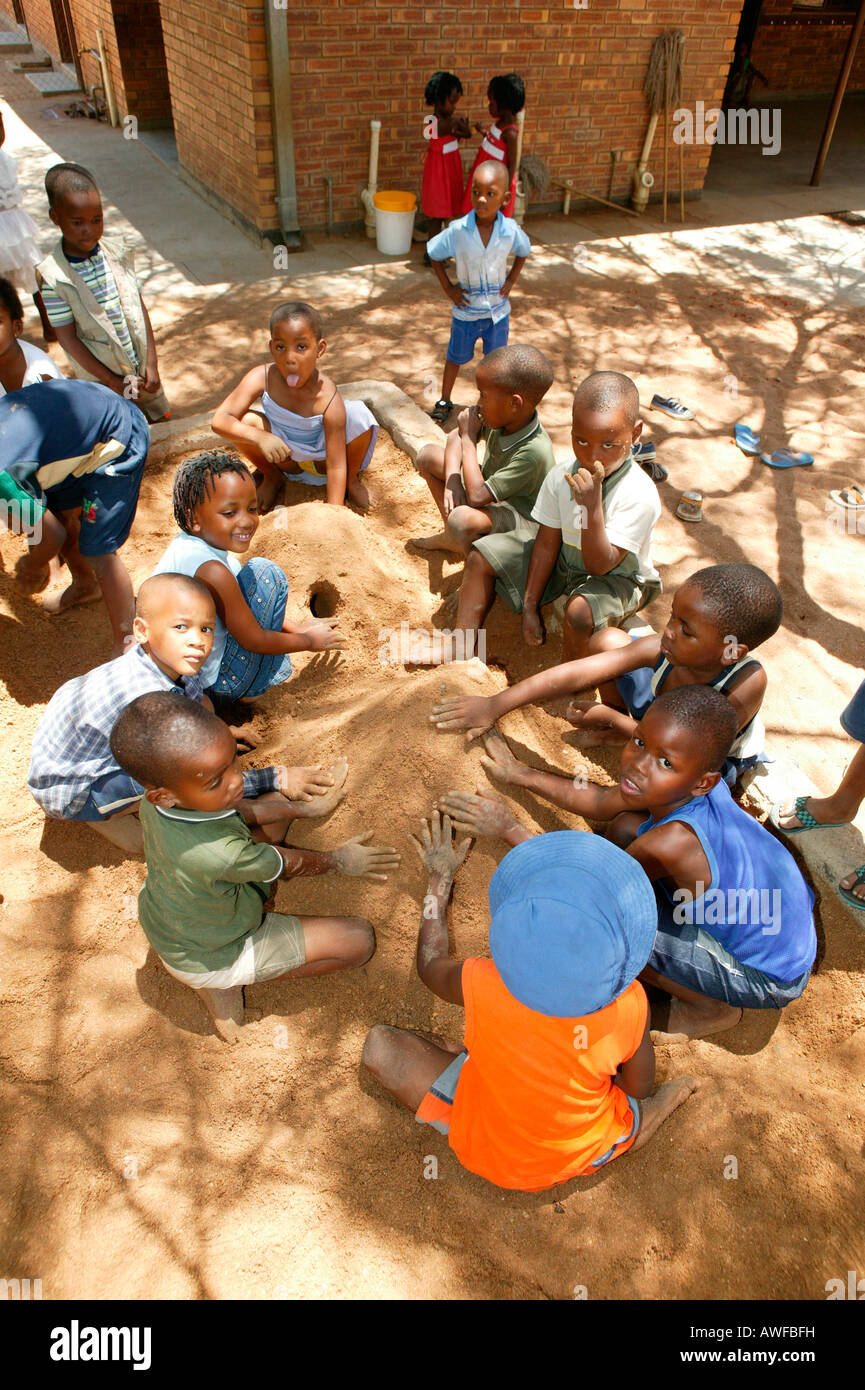 Children playing in the sand at a kindergarten, Gaborone, Botswana, Africa Stock Photo