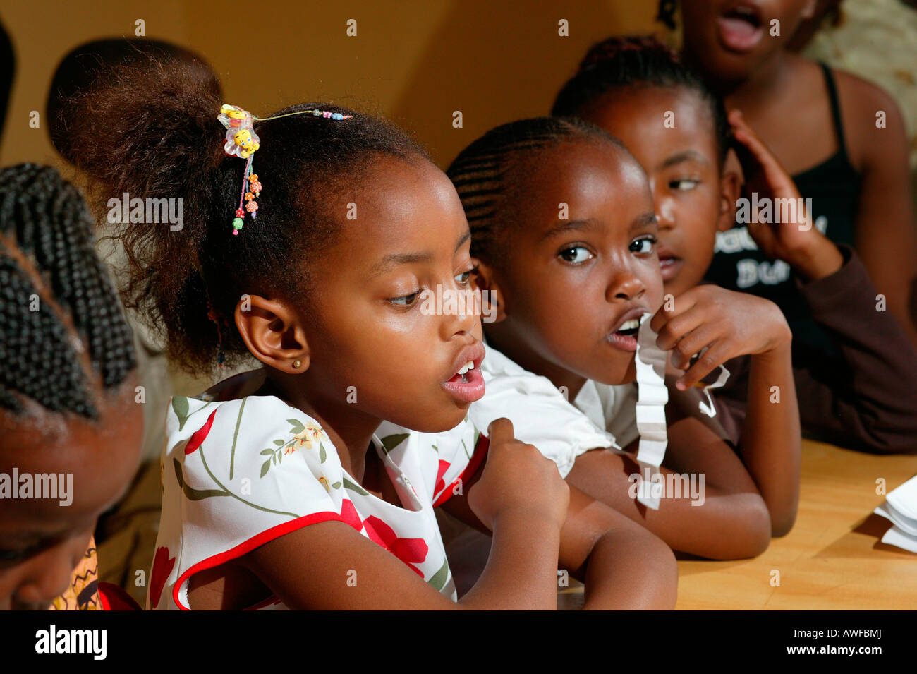 Children sitting at a table, Francistown, Botswana, Africa Stock Photo