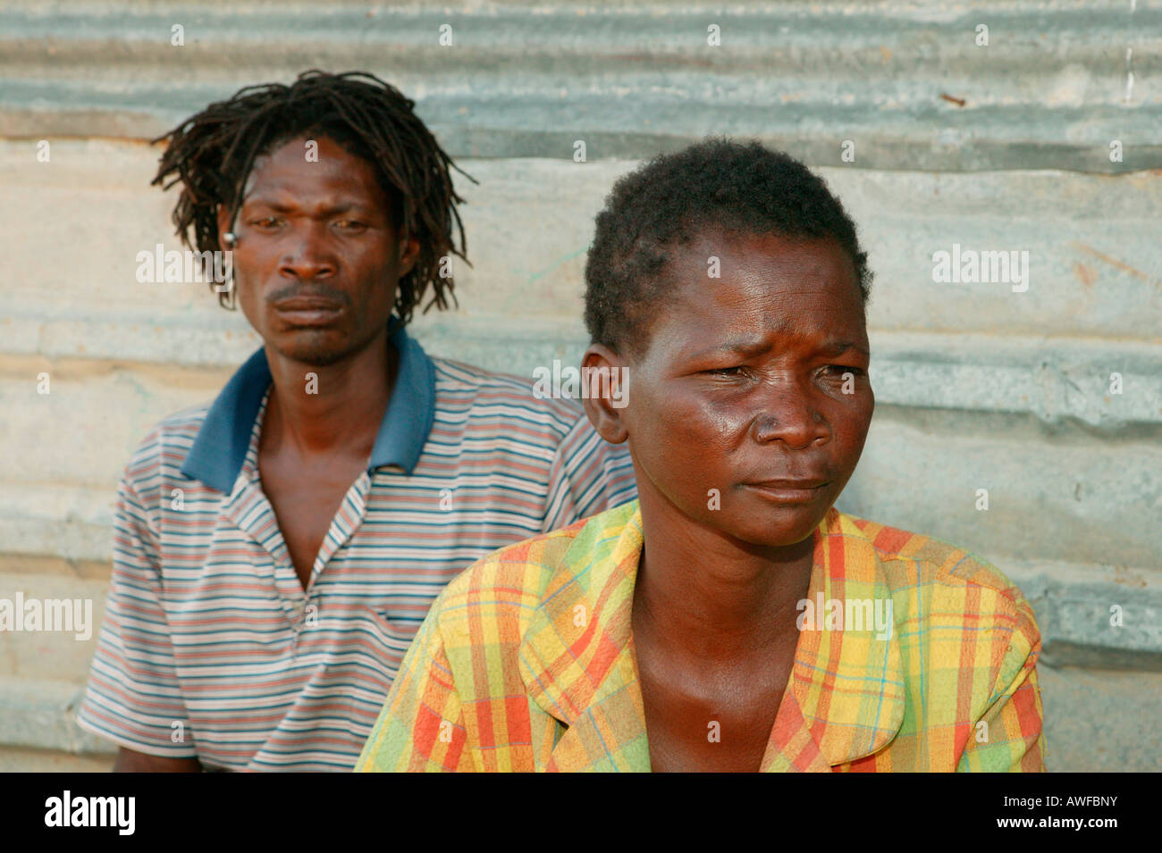 HIV/AIDS infected couple in front of their corrugated metal hut, Francistown, Botswana, Africa Stock Photo