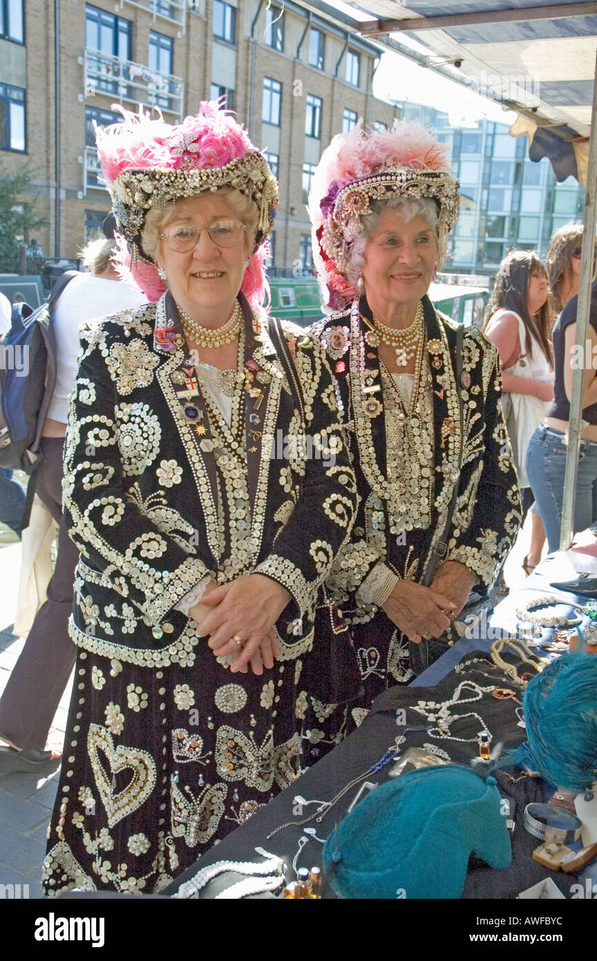 Pearly Queens of Hackney and Islington next to a jewelery stall at the Angel Festival Islington London England UK Stock Photo