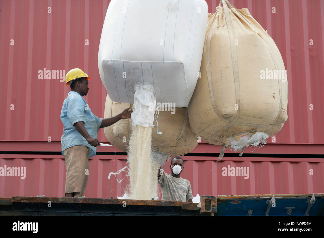 Dock workers loading rice at John Fernandes transshipment port in Georgetown, Guyana, South America Stock Photo