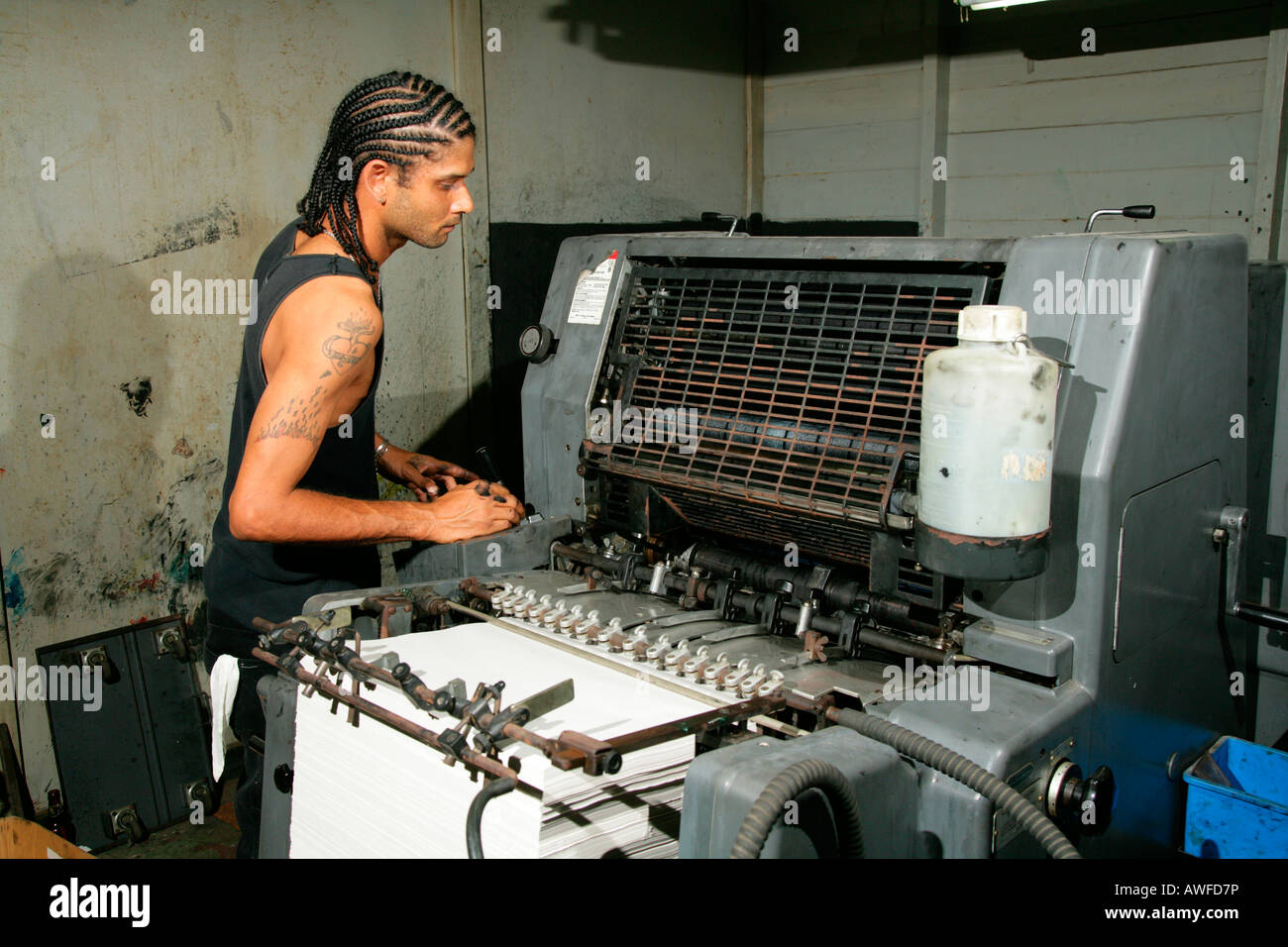 Printer cleaning a printing press at the Catholic Standard printing