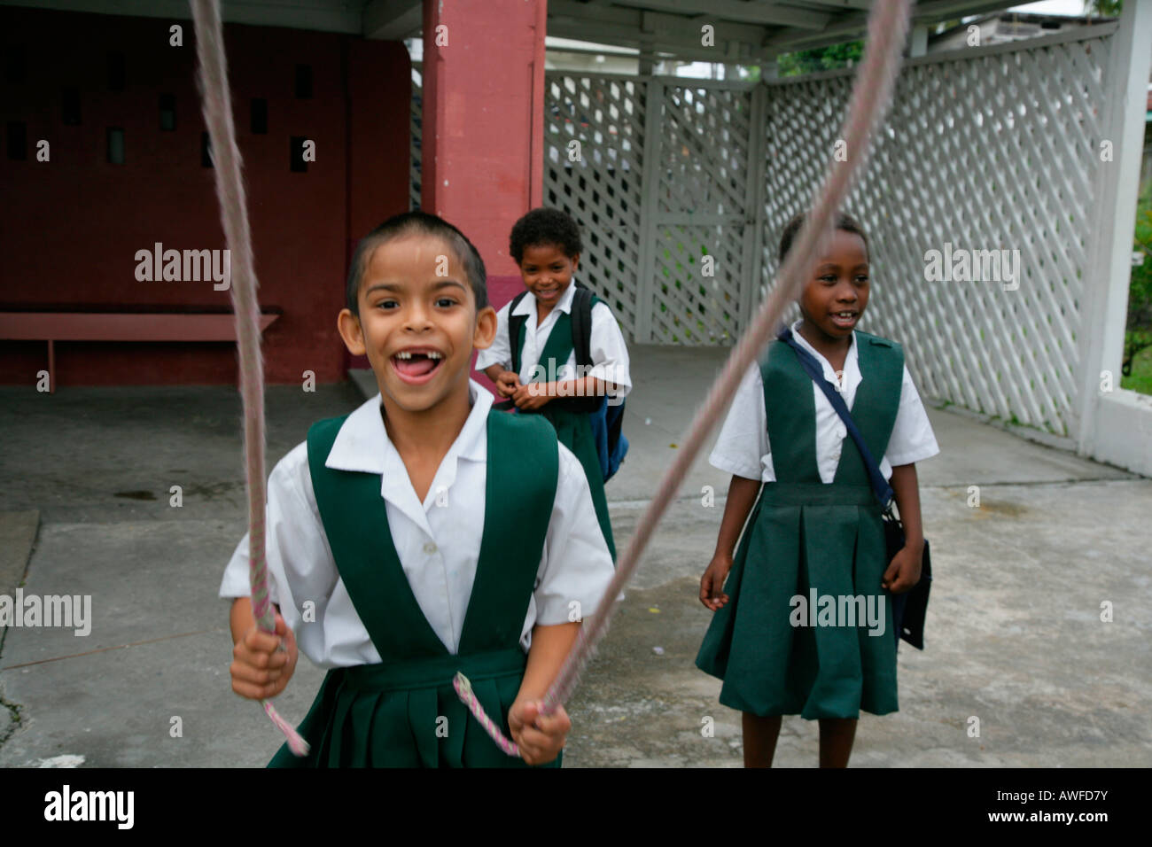 Girls dressed in school uniforms playing with a skipping rope at an Ursuline  convent and orphanage in Georgetown, Guyana, South Stock Photo - Alamy