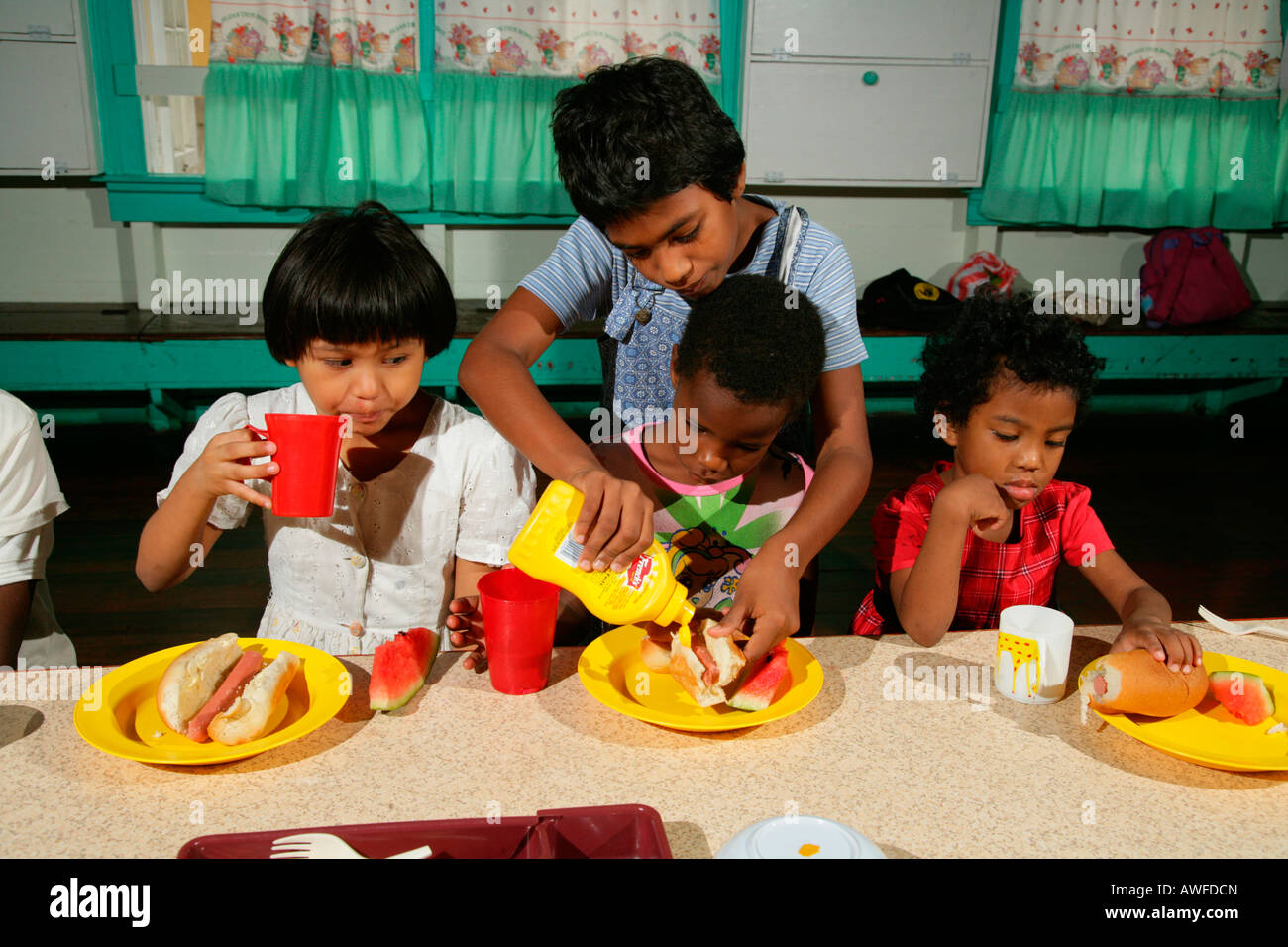 Girls with full plates, everyday life at an Ursuline convent and orphanage, Georgetown, Guyana, South America Stock Photo