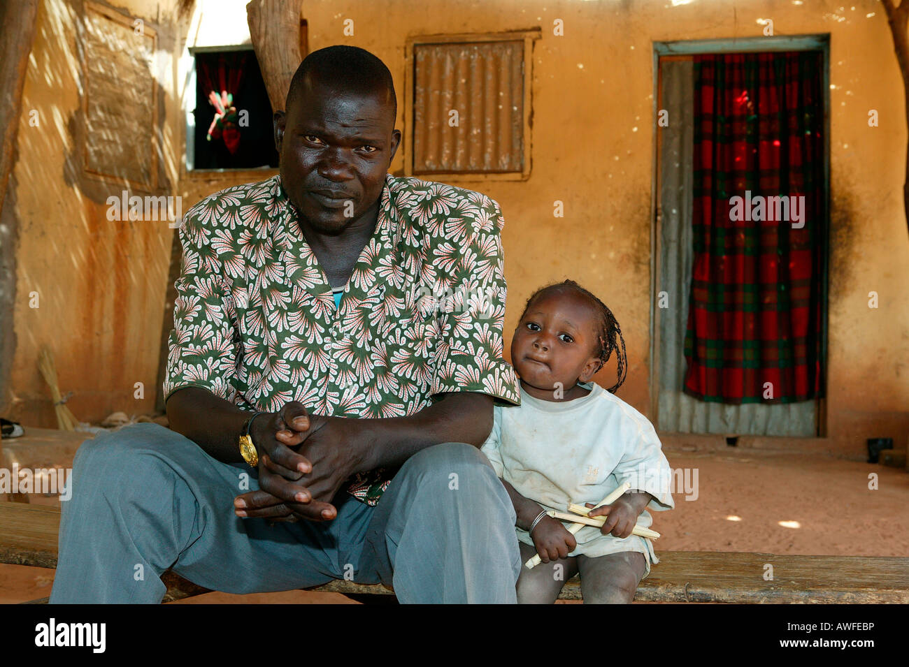 Father and half-orphaned child, HIV/AIDS infected, Cameroon, Africa Stock Photo