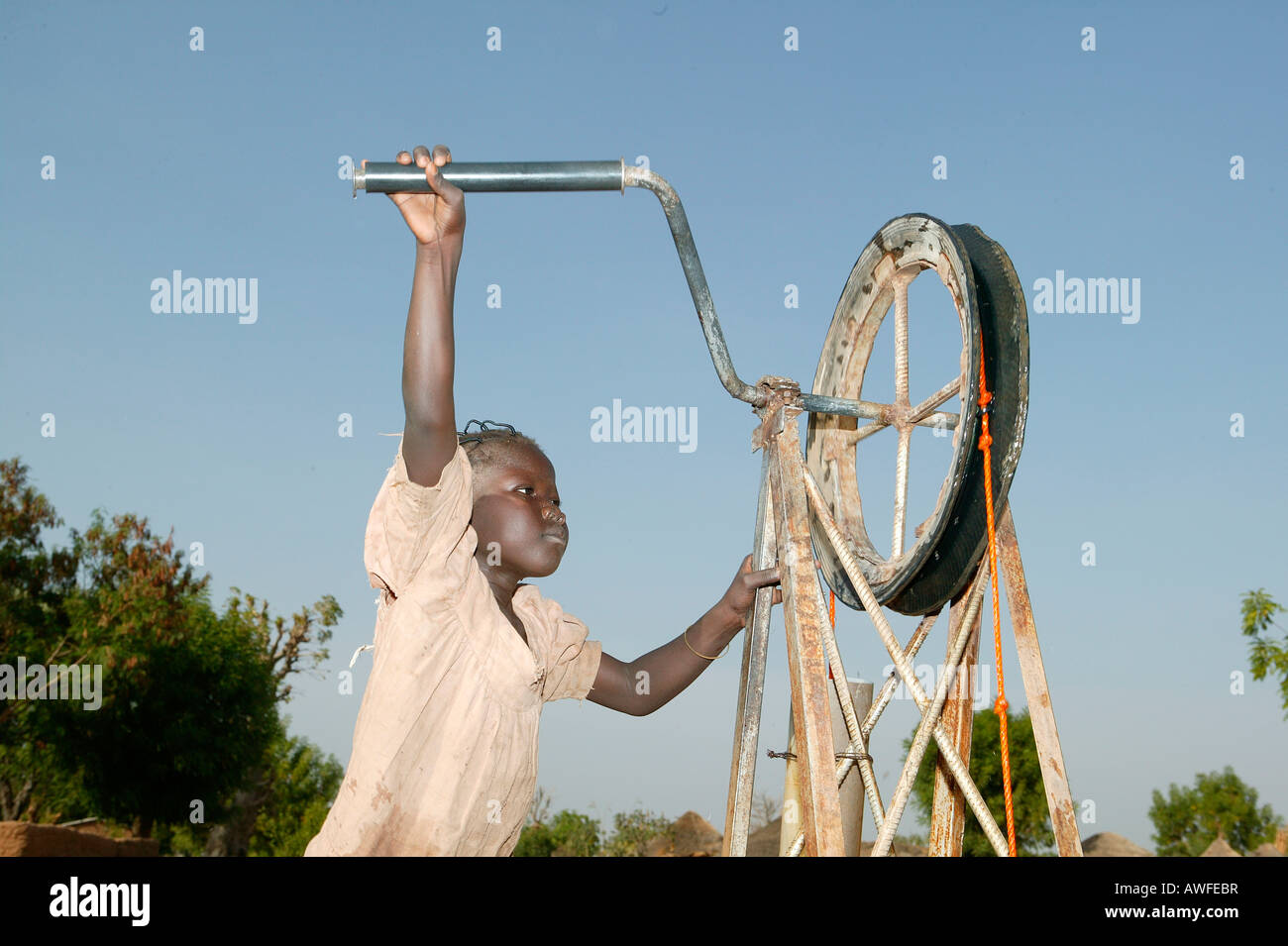 Boy fetching water from a well, Cameroon, Africa Stock Photo