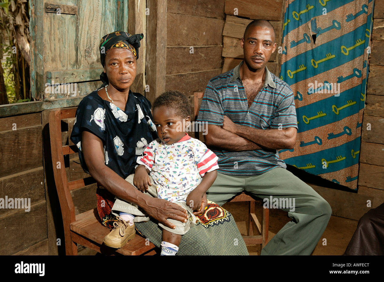 Father and grandmother with AIDS orphan, Cameroon, Africa Stock Photo