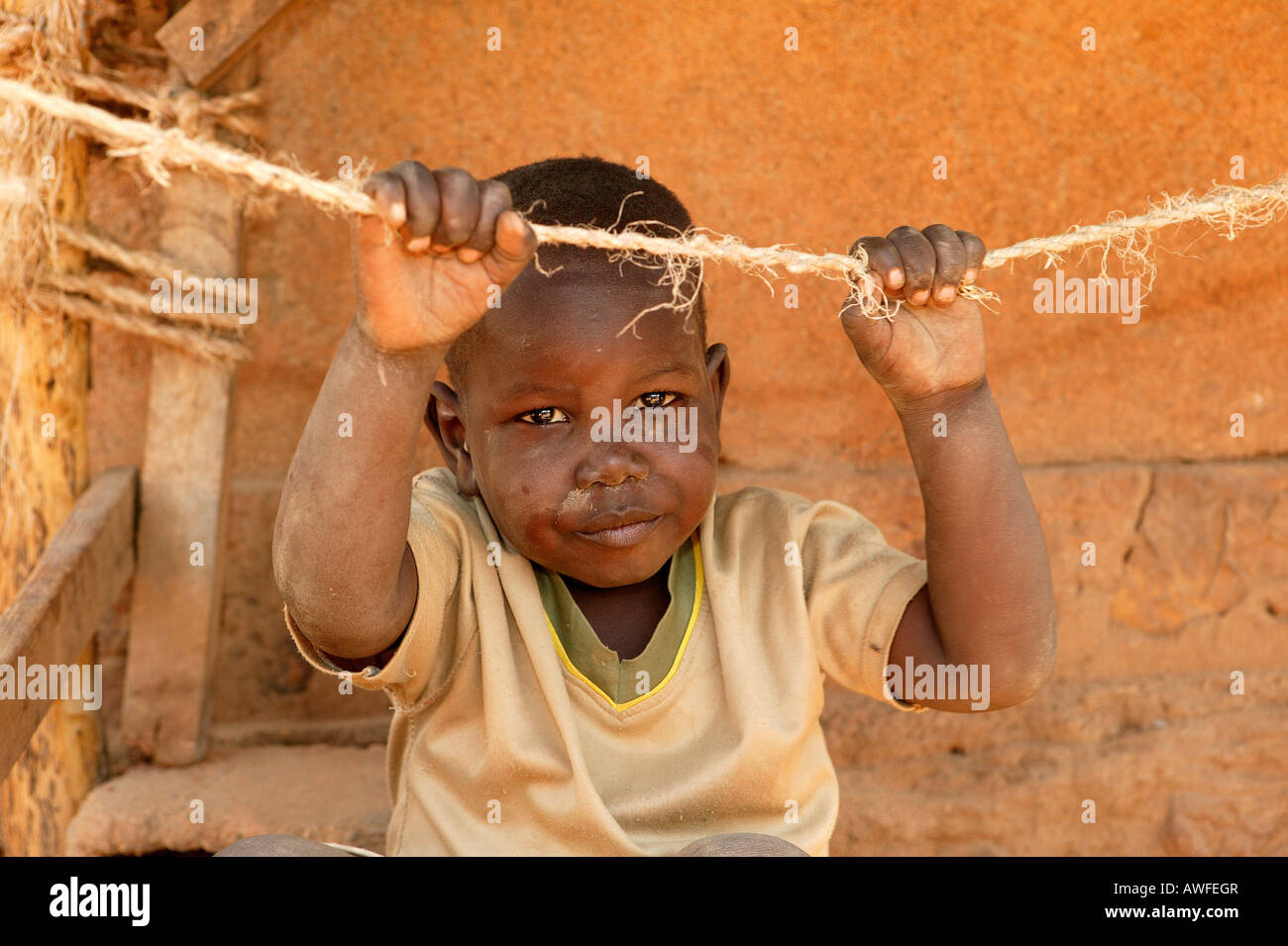 Boy clutching a rope, Cameroon, Africa Stock Photo