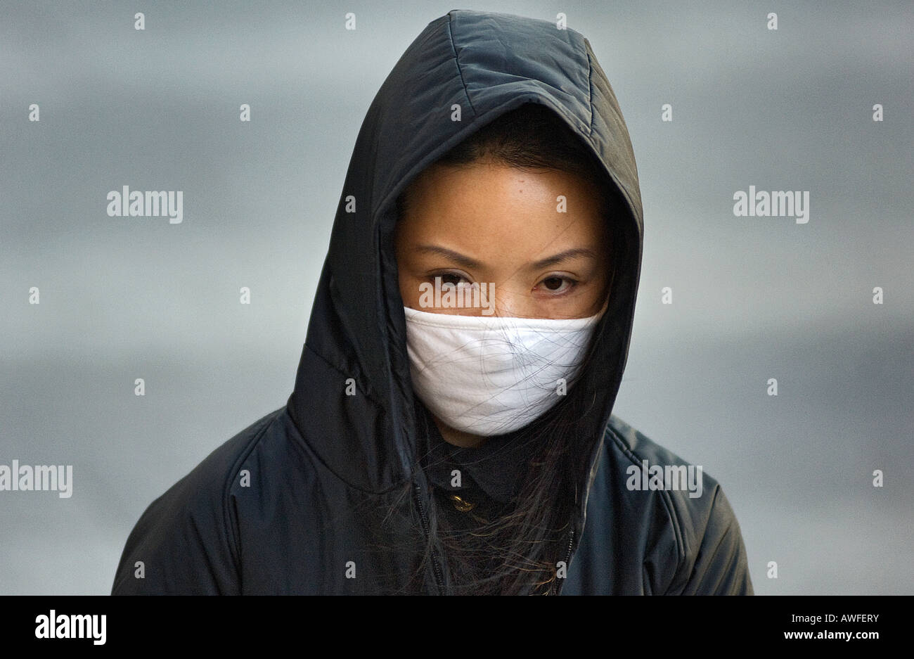 Pollution and poor air quality drive many Beijing locals to wear facemasks in the street, including this woman in Wanfujing. Stock Photo