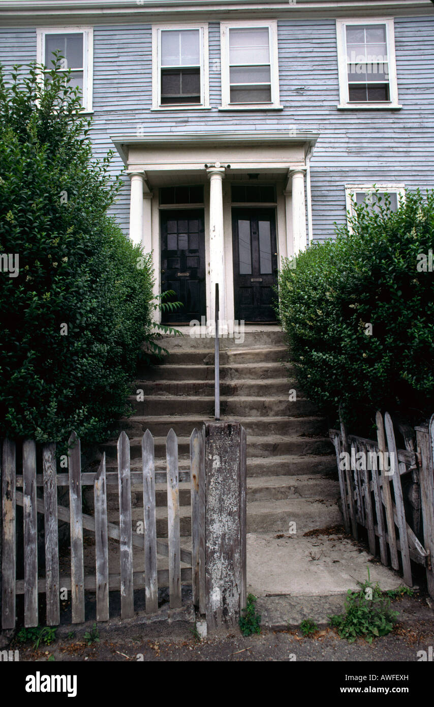 Broken gate and entryway to a multifamily house in Chelsea