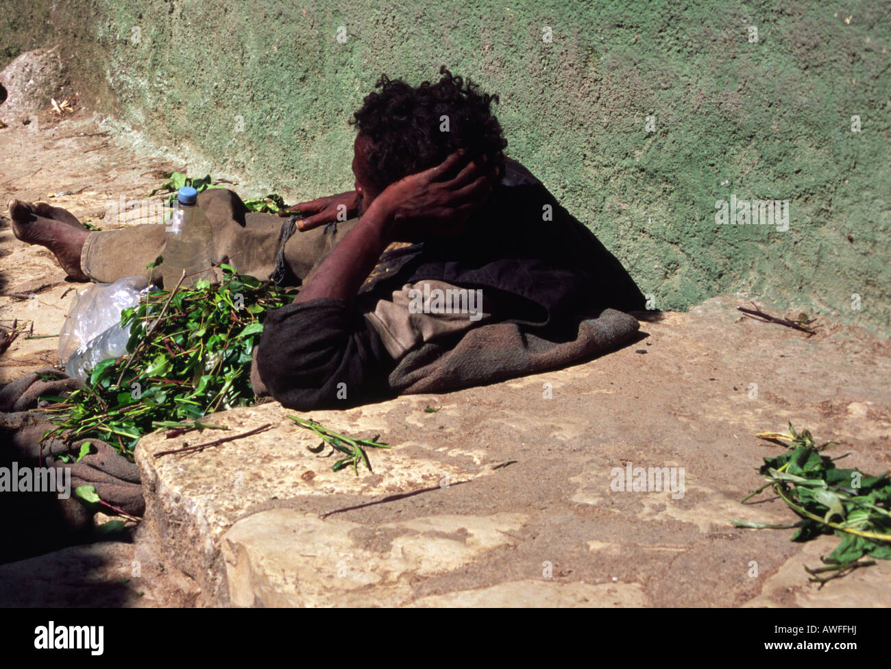 A Qat addict lies in the street of Harar, Ethiopia. Stock Photo