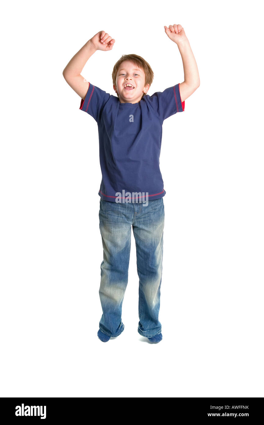 A young boy jumping in the air against a white background with slight motion blur Stock Photo
