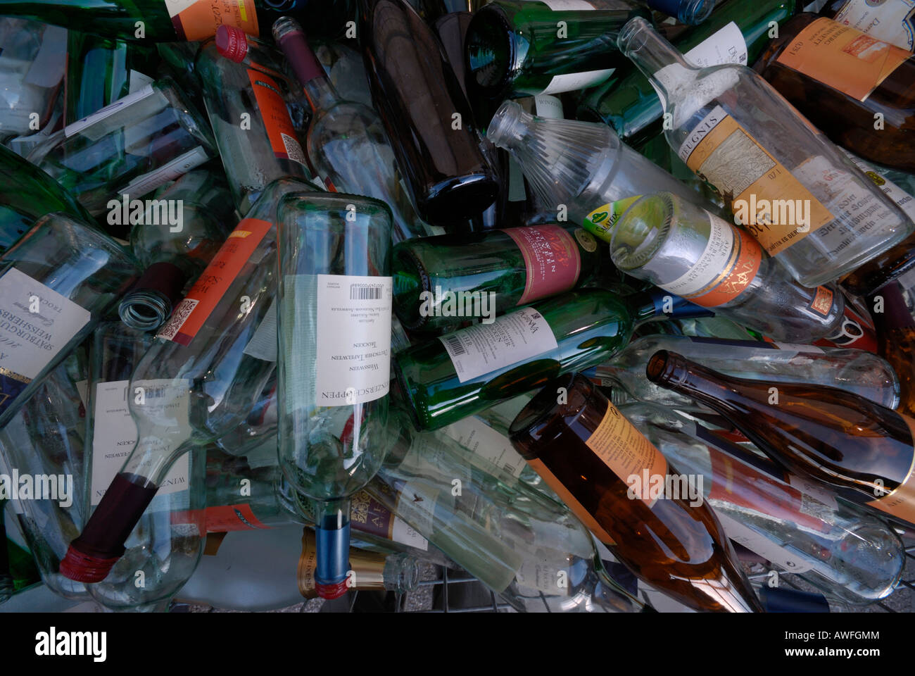 Wine bottles in a glass recycling bin Stock Photo