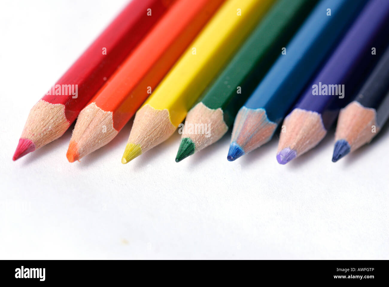 Seven pencil crayons arranged in a row Stock Photo Alamy