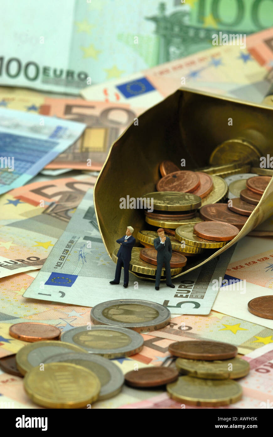 Two businessmen mulling over how to rake in even more Euros Stock Photo