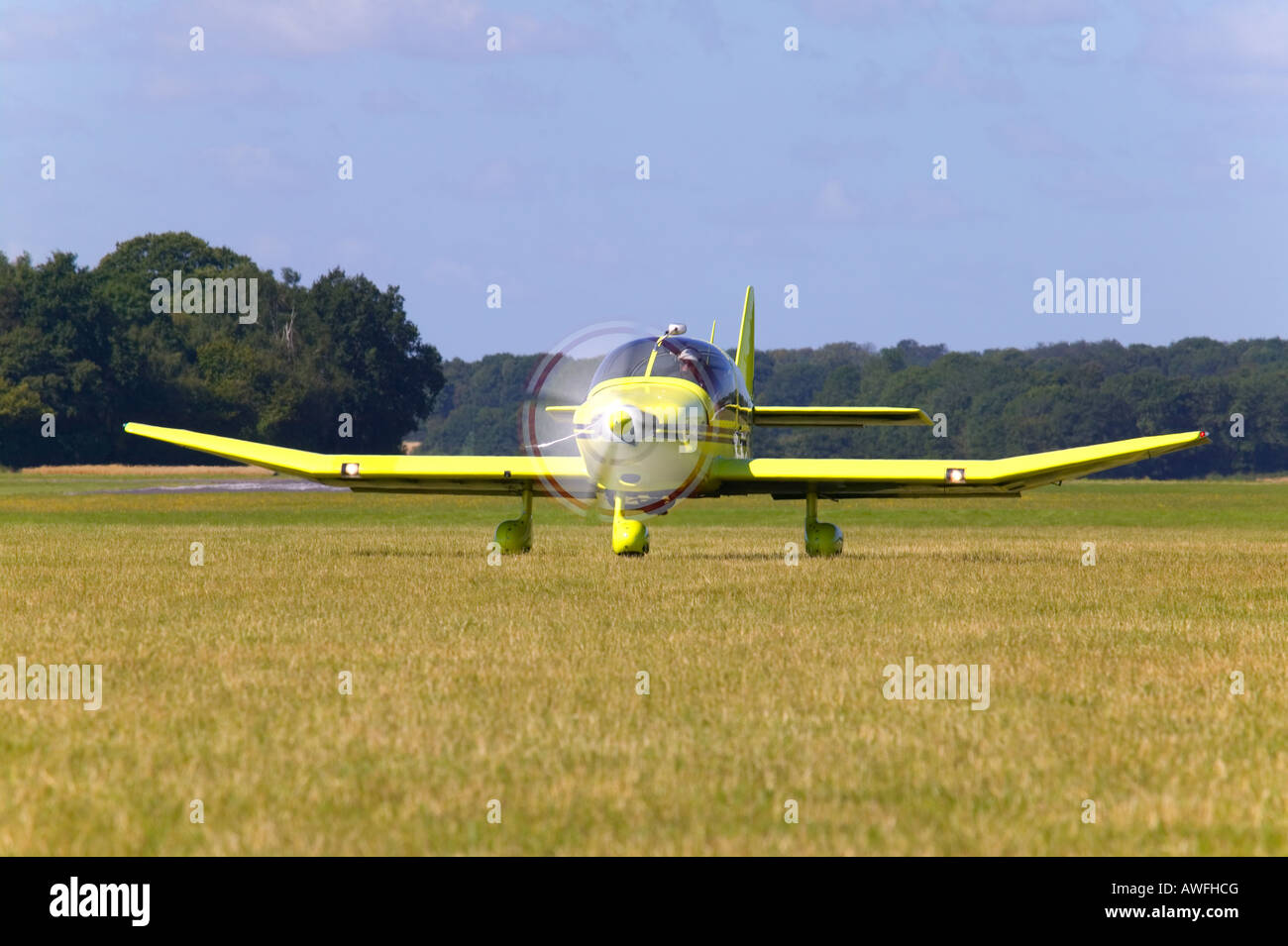 A yellow single propeller light aircraft taxiing to take off from Lasham airfield in Hampshire England Stock Photo